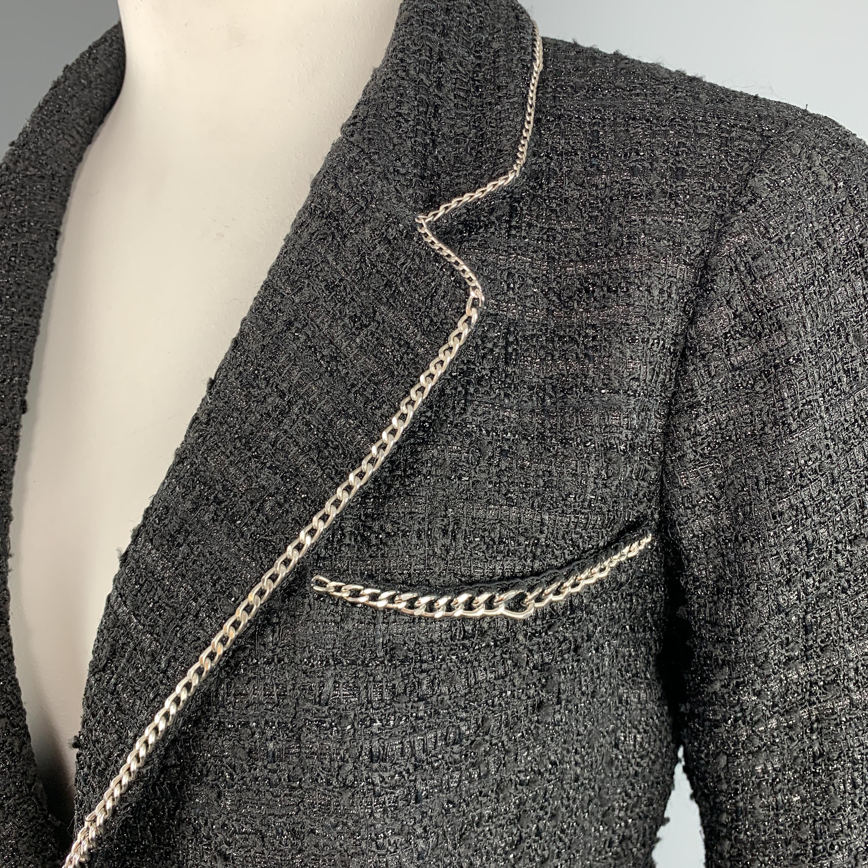 Spring 2006 Chanel metallic black tweed blazer with silver-tone chain-link trim piping throughout, notch lapel, three pockets, double vented back, hidden button sleeves with CC accent, silk lining, and single hook and eye closure at front. Made in