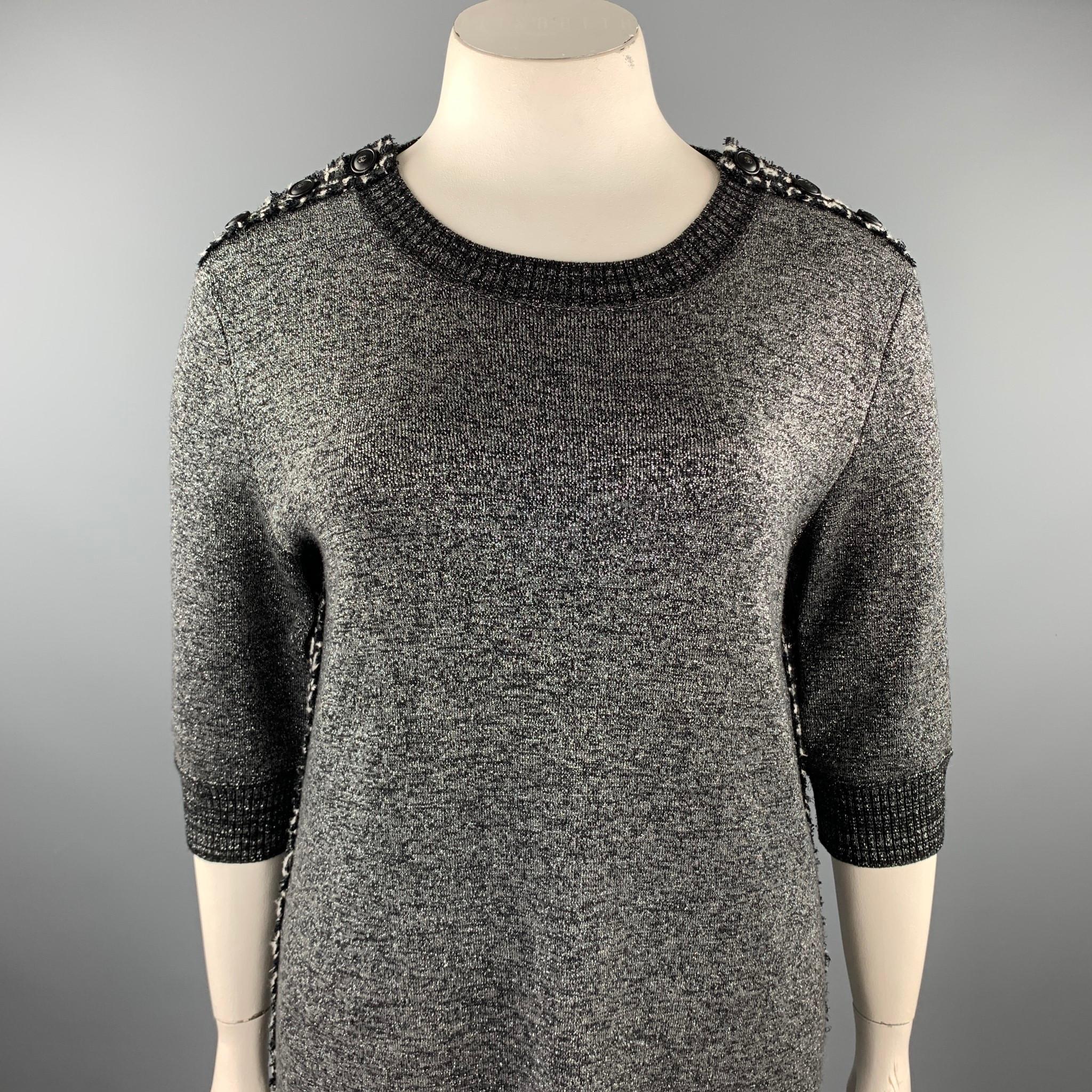 CHANEL dress comes in a silver knitted textured wool blend featuring a shift style, double C button details, 3/4 sleeves, and a wide neck. Made in Italy.

Excellent Pre-Owned Condition.
Marked: 46

Measurements:

Shoulder: 20 in. 
Bust: 44 in.