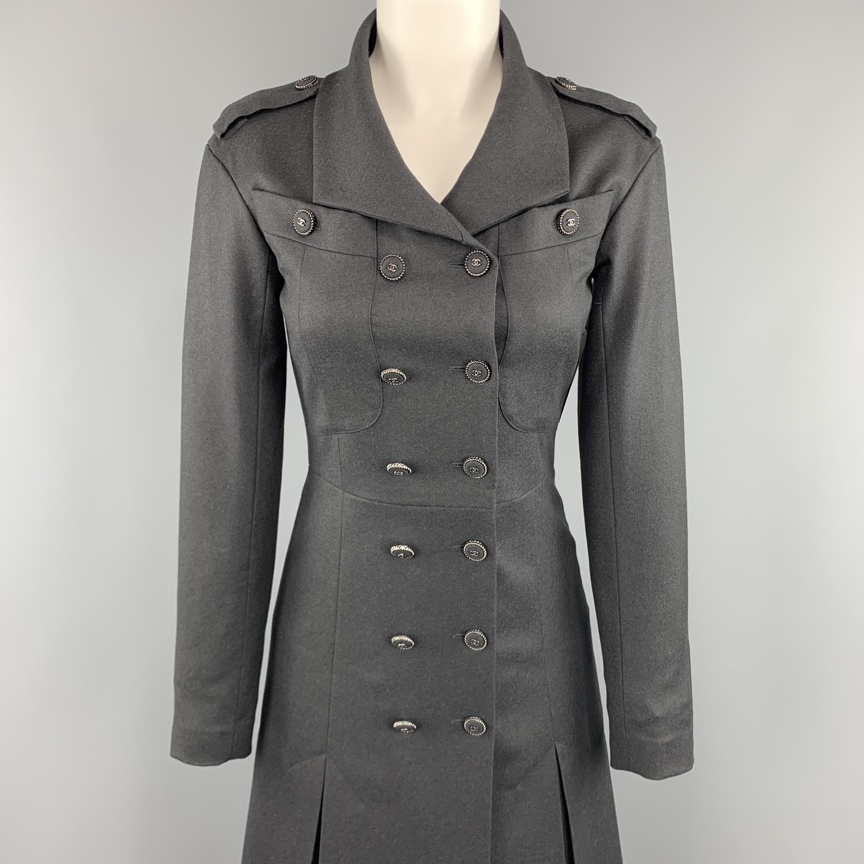 CHANEL trench coat comes in charcoal gray wool cashmere twill with a geometric lapel, epaulets, breast pockets, double breasted front with silver tone metal fabric CC logo buttons, three button cuffs, and A line skirt with box pleated hem. Made in