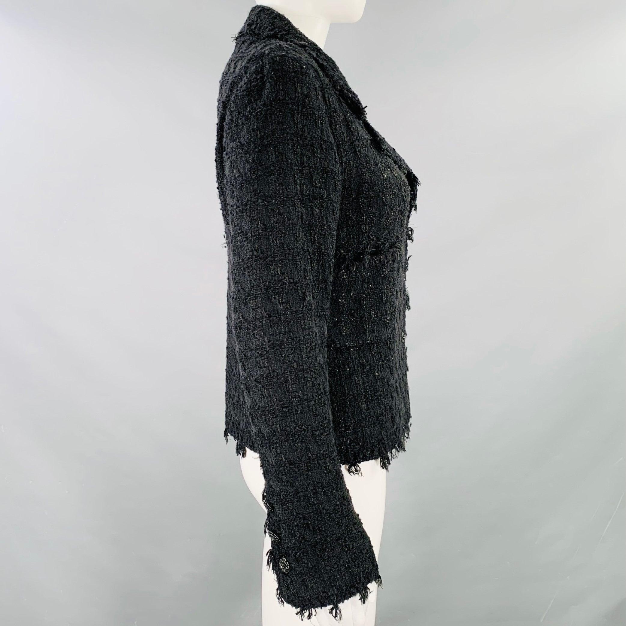 CHANEL blazer
in a black cotton blend boucle featuring raw edges, notch lapel, and button closure with signature camellia buttons. Made in France.Very Good Pre-Owned Condition. Minor signs of wear on camellia buttons. 

Marked:   FR 36
