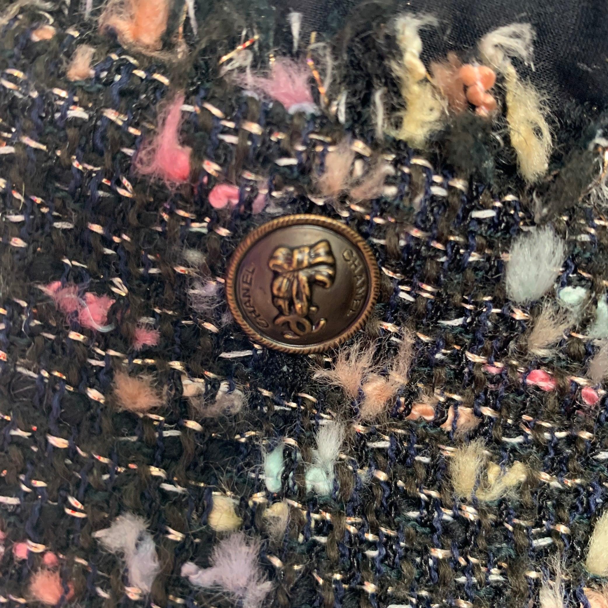 CHANEL jacket comes in a multi-color boucle wool blend featuring a spread collar, silk trim, CC logo button detail, and a open front. Made in France. Very Good Pre-Owned Condition. 

Marked:   B2619 04A / 34 

Measurements: 
 
Shoulder: 15 inches