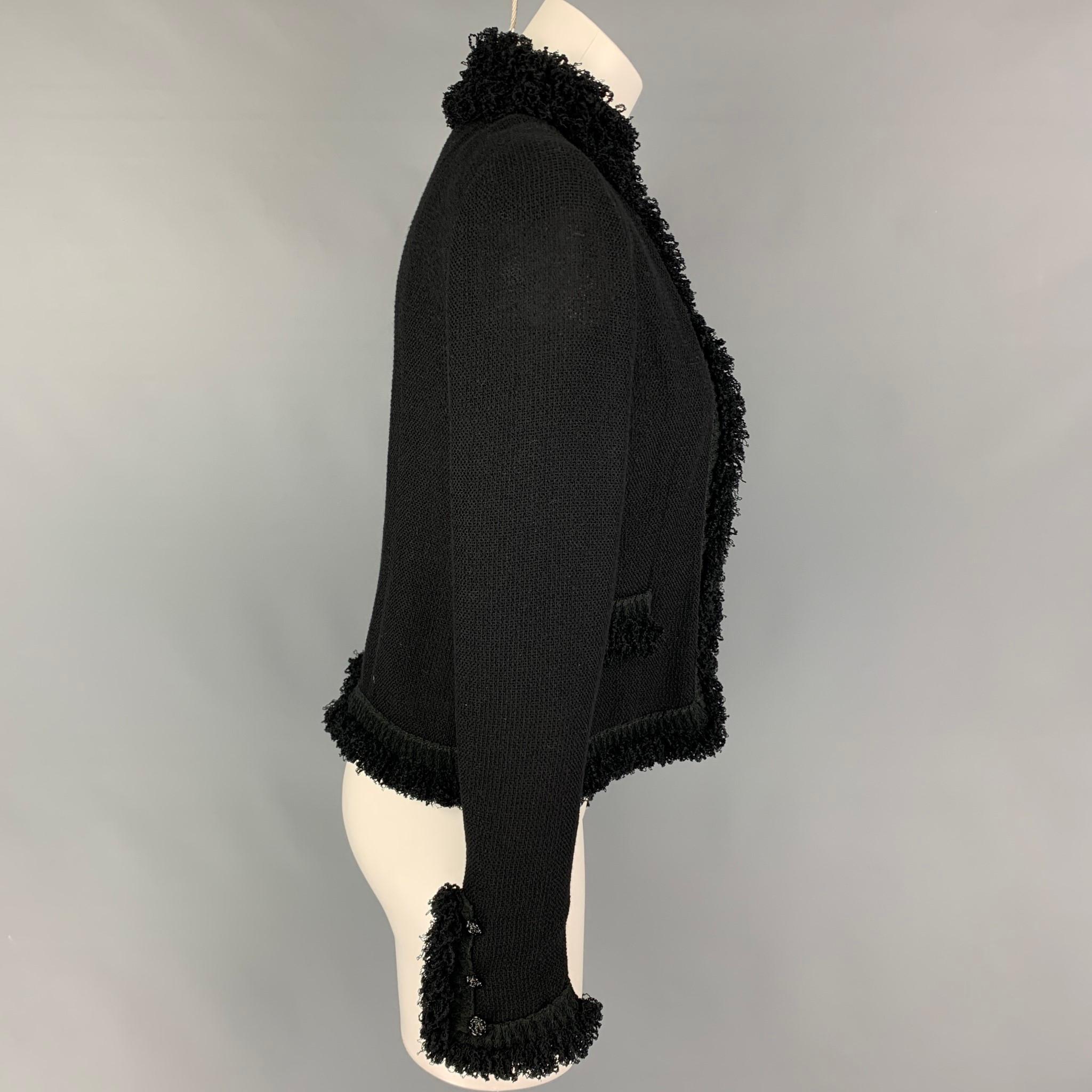 CHANEL jacket comes in a black wool blend featuring a ruffled trim, front pockets, and a single button closure. Made in France. 

Very Good Pre-Owned Condition.
Marked: 03C / 94305 36

Measurements:

Shoulder: 14.5 in.
Bust: 34 in.
Sleeve: 26