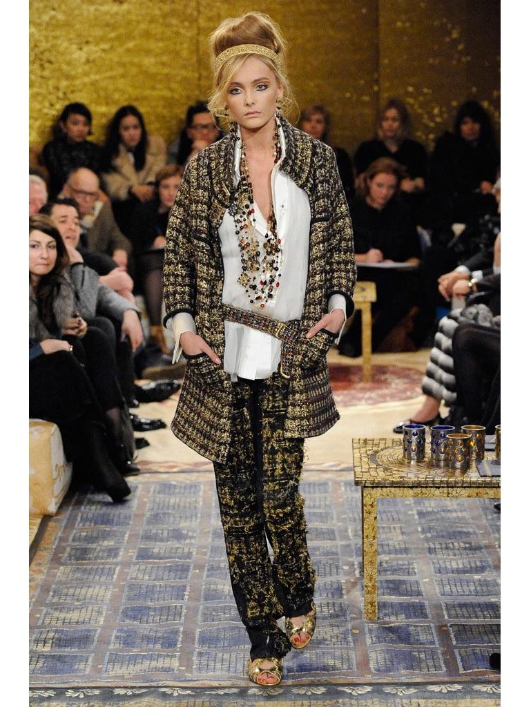CHANEL Pre-Fall 2011 coat comes in navy and beige wool cashmere blend tweed knit with hints of burgundy and tan brown with an all over metallic gold splatter paint effect and features a high collar, three quarter sleeves, four patch pockets, and