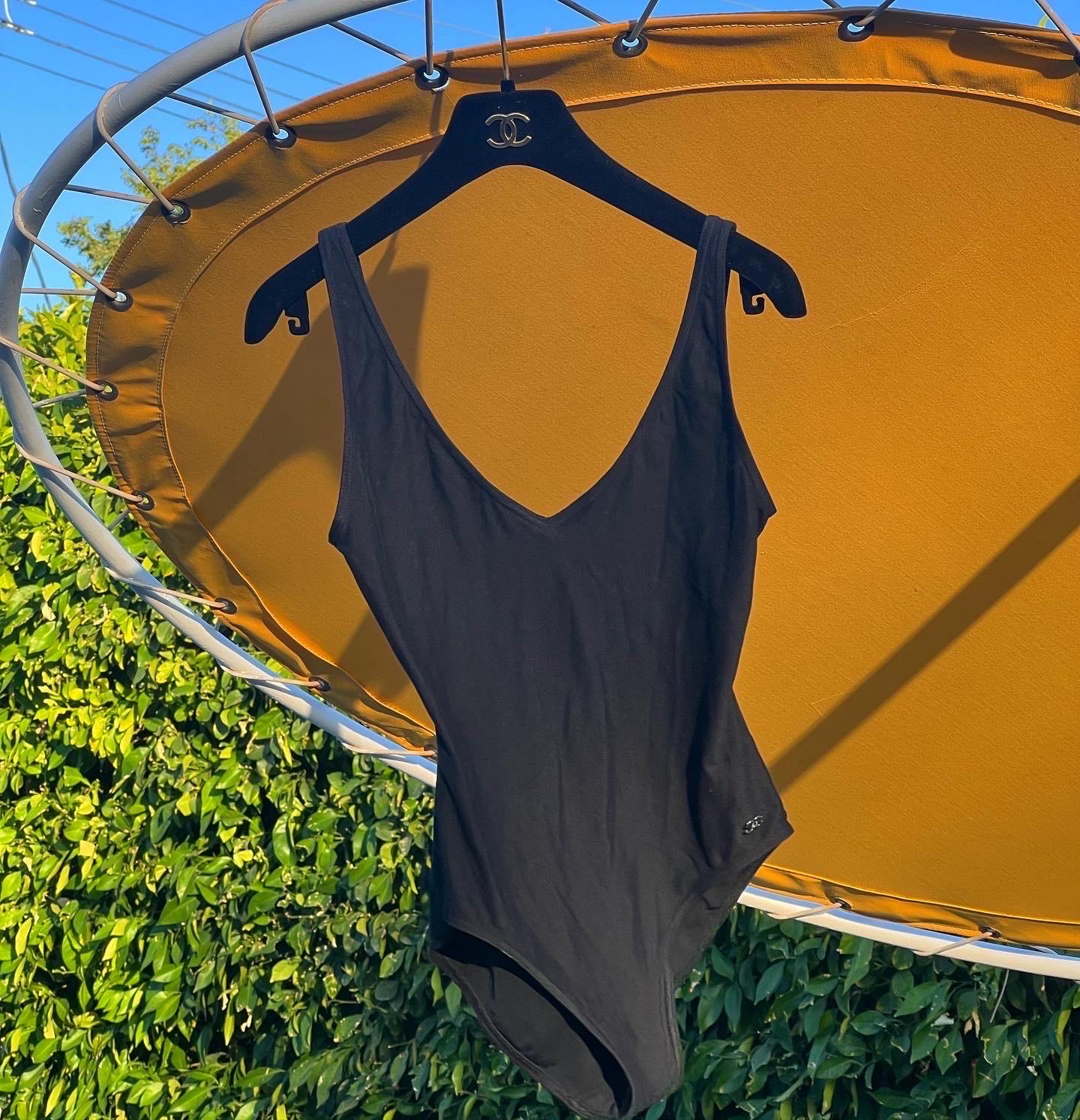 Chanel Swim? Name something better! Feel sleek and expensive in this blacked-out Chanel swim piece! Snag this today as it is a perfect basic to keep in your closet. This one-piece will hold you tight in all the right places to make you feel your