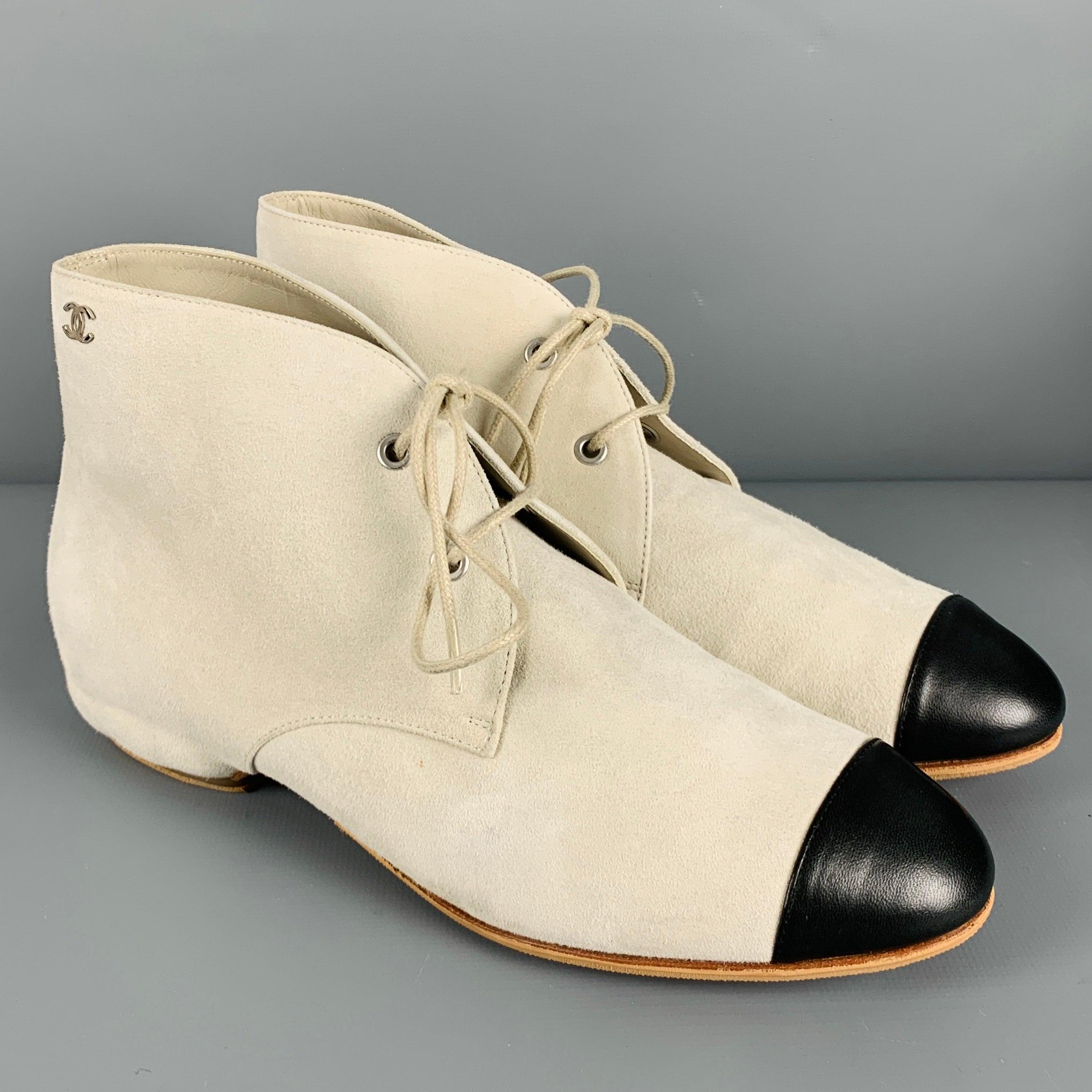 CHANEL boots
in a
grey suede fabric featuring an ankle style, contrast black leather cap toe, and lace-up closure. Comes with box and dust bag. Made in Italy. Note: these shoes have been resoled with a nonslip material.Very Good Pre-Owned Condition.