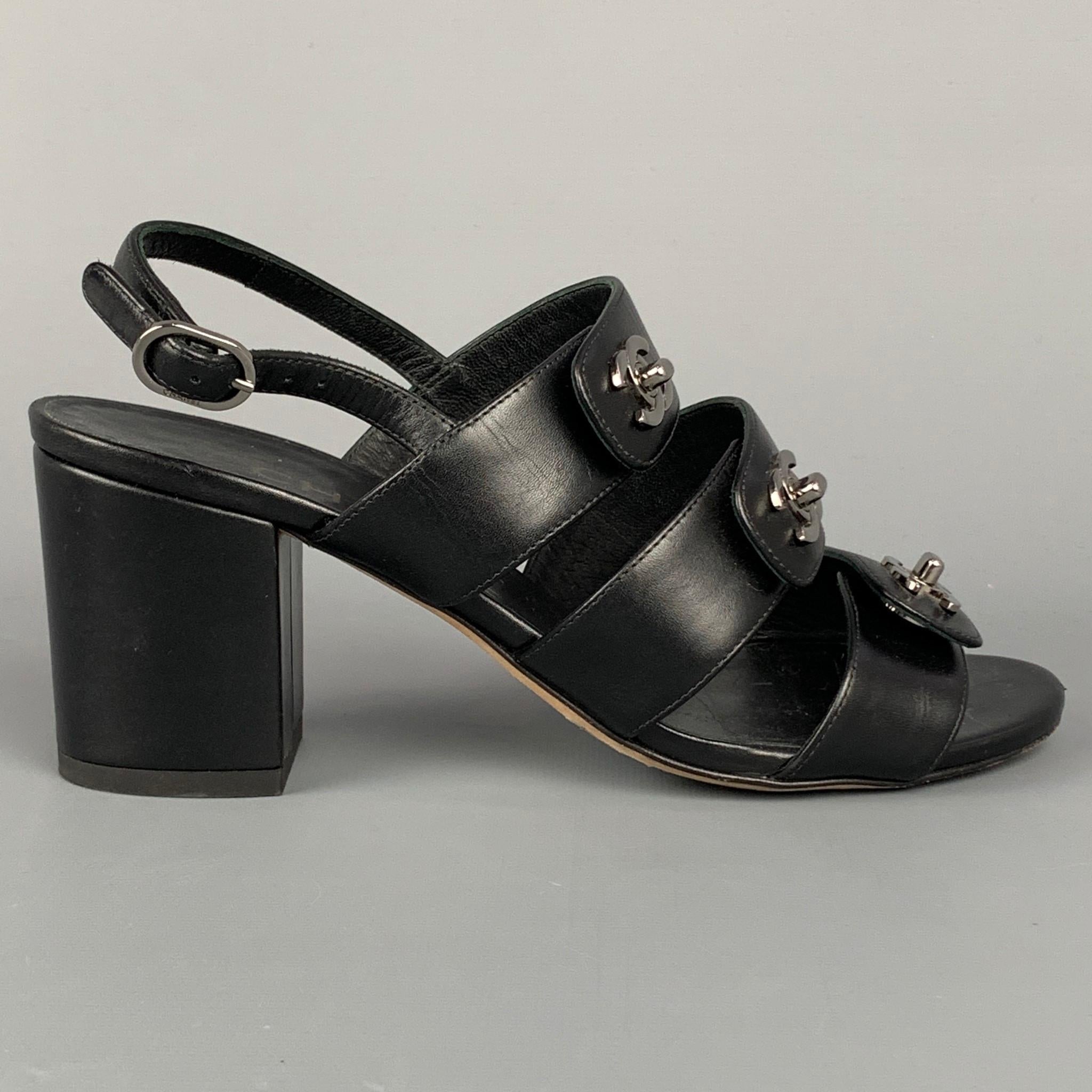 CHANEL sandals comes in a black leather featuring a ankle strap, three straps, turn lock silver tone logo hardware designs, and a chunky heel. Made in Italy.

Very Good Pre-Owned Condition.
Marked: EU 36

Measurements:

Heel: 3 in.