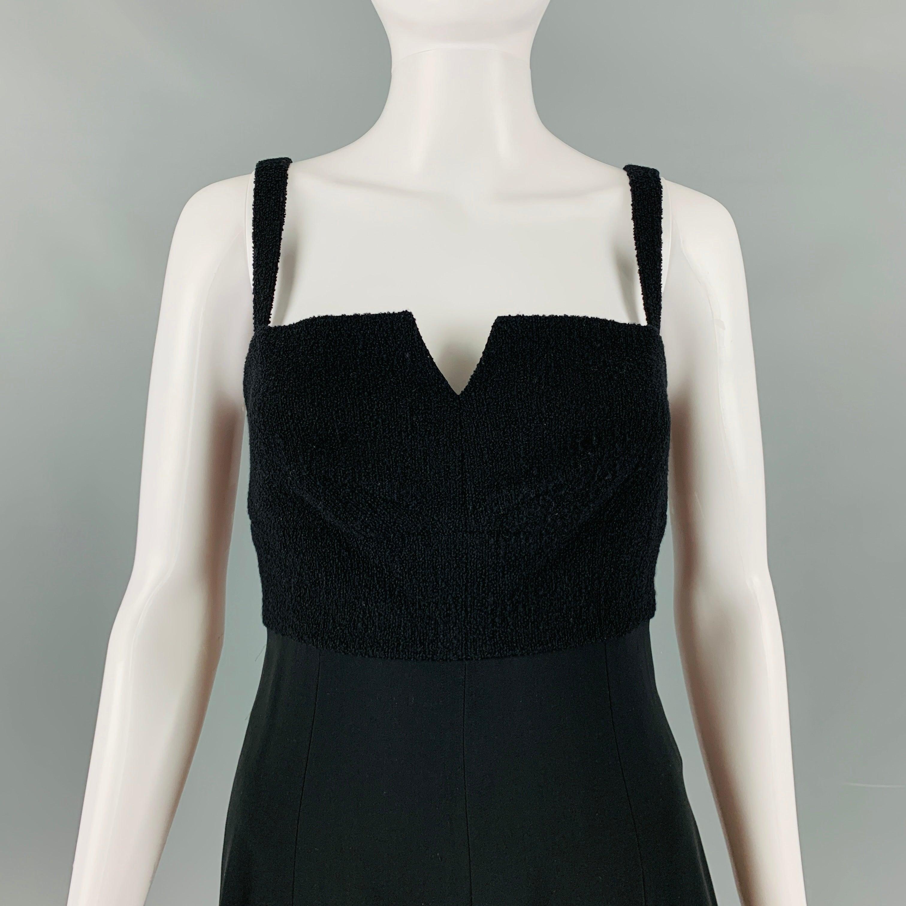 CHANEL 97 below knee dress comes in black black wool woven with a empire waist and a zip up closure at back. Made in France.Excellent Pre- Owned Conditions. 

Marked:   6 

Measurements: 
  Bust: 32 inches Waist: 26 inches Hip: 37 inches Length: 37