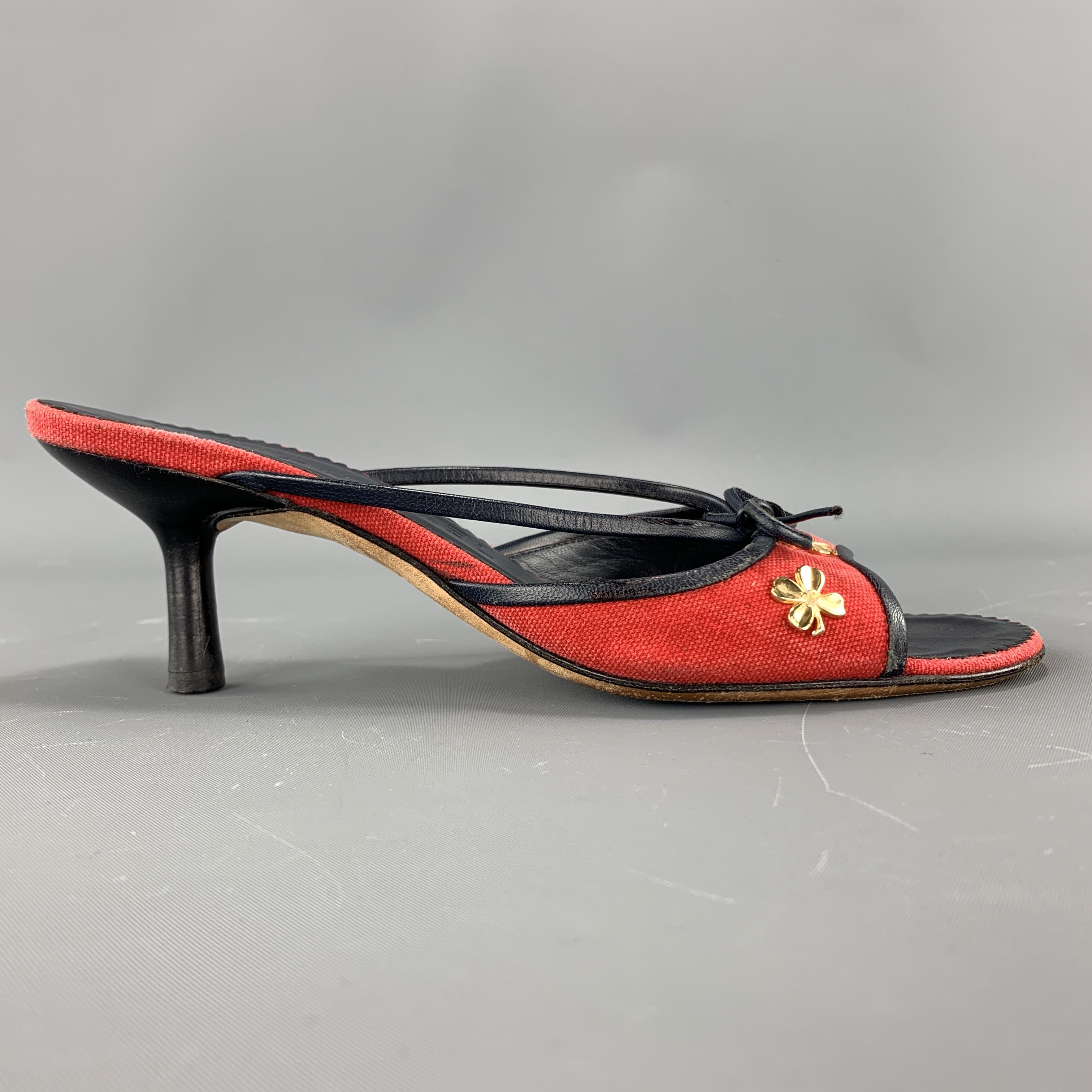 Vintage CHANEL mules come in red canvas with navy leather piping, kitten heel, bow strap, and gold tone CC clover studs. Made in Italy.

Good Pre-Owned Condition.
Marked: IT 36

Heel: 2.75 in.