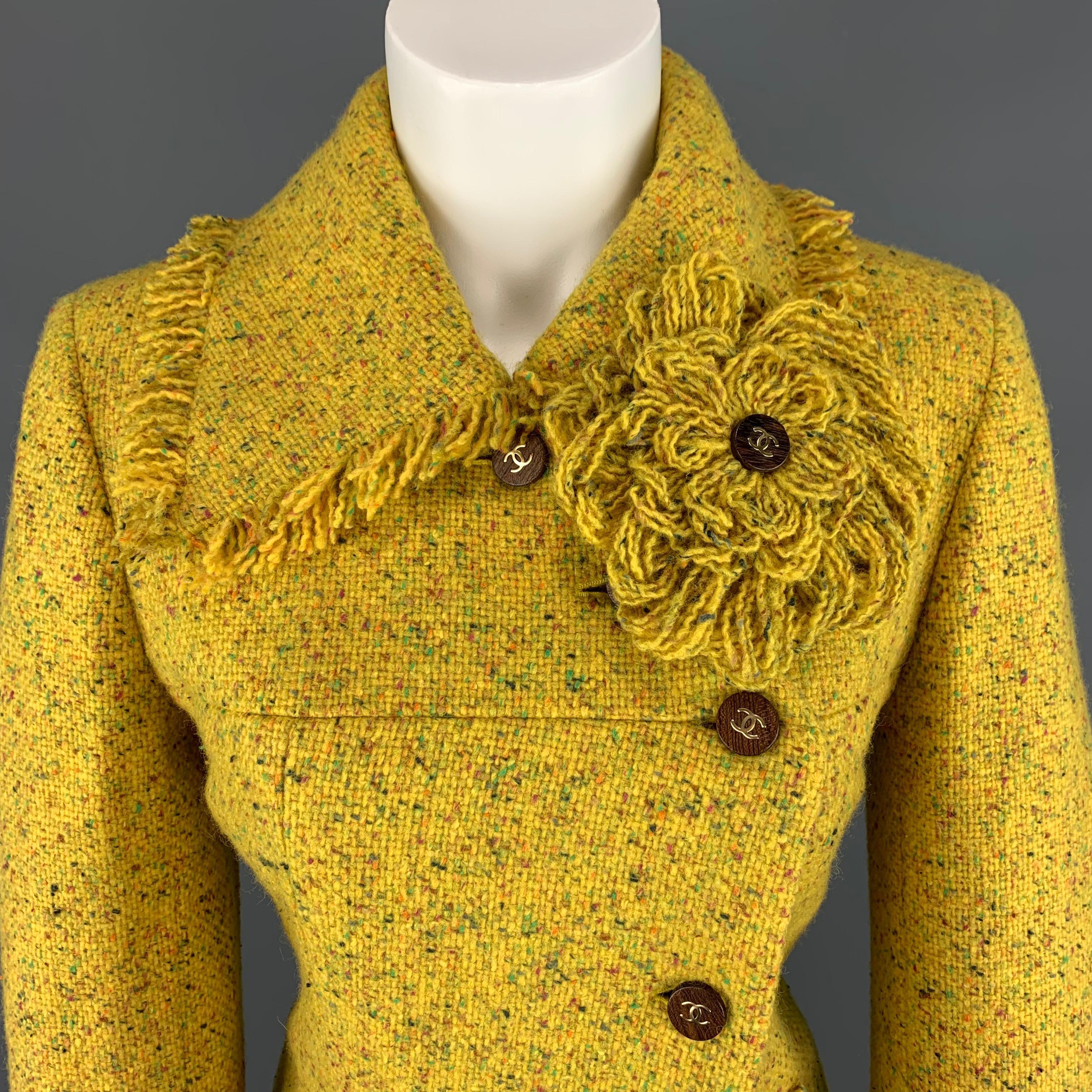 Archive circa 2001 CHANEL jacket comes in canary yellow wool blend tweed with multi color speckled pattern throughout and features a pointed collar with fringe trim, tweed flower brooch, asymmetrical closure with wooden CC buttons, slit pockets,