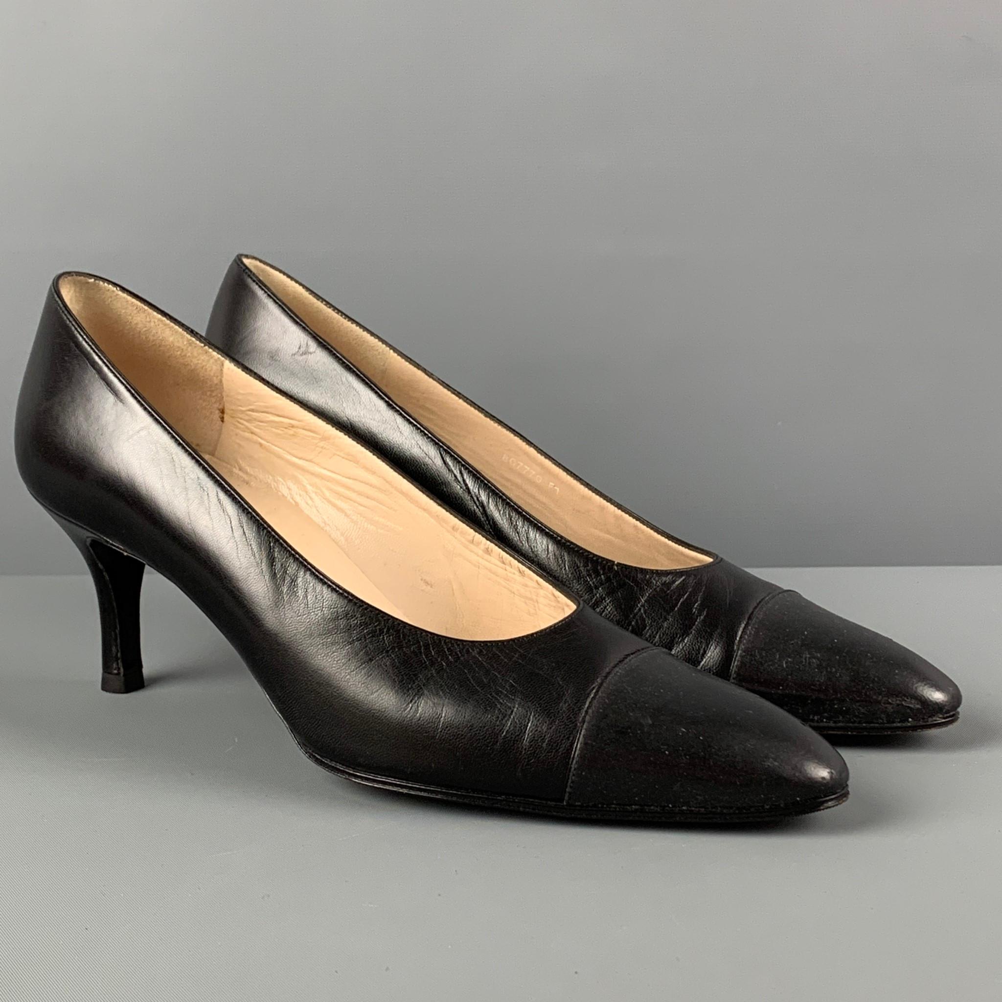 CHANEL pumps comes in a black leather featuring a cap toe and a kitten heel. Made in France. 

Very Good Pre-Owned Condition.
Marked: 37.5

Measurements:

Heel: 2.75 in. 