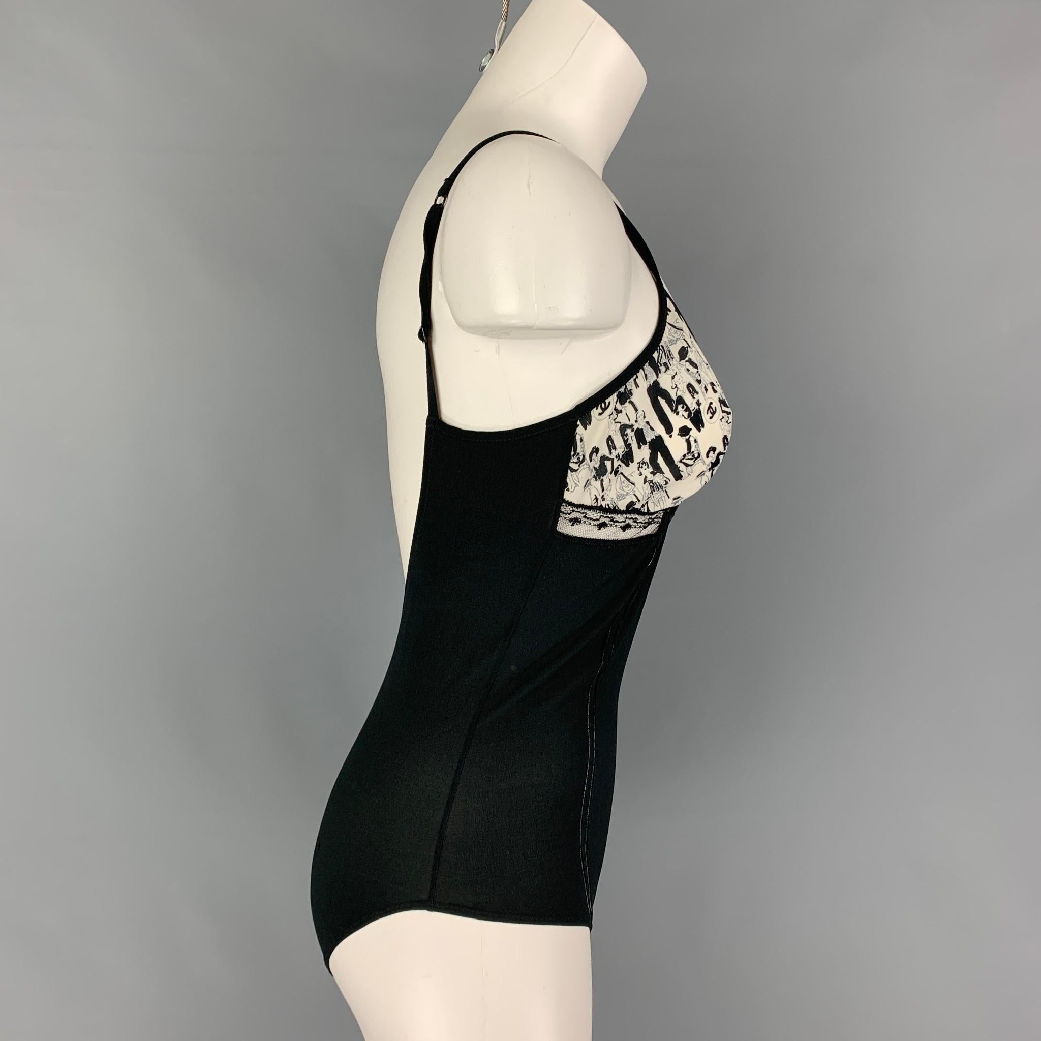 CHANEL body suit top comes in a black & white silk featuring a mademoiselle print panel, lace trim, spaghetti straps, open back, and a snap button closure. Made in Italy. 

Very Good Pre-Owned Condition.
Marked: 03P / B2229 40
Original Retail Price: