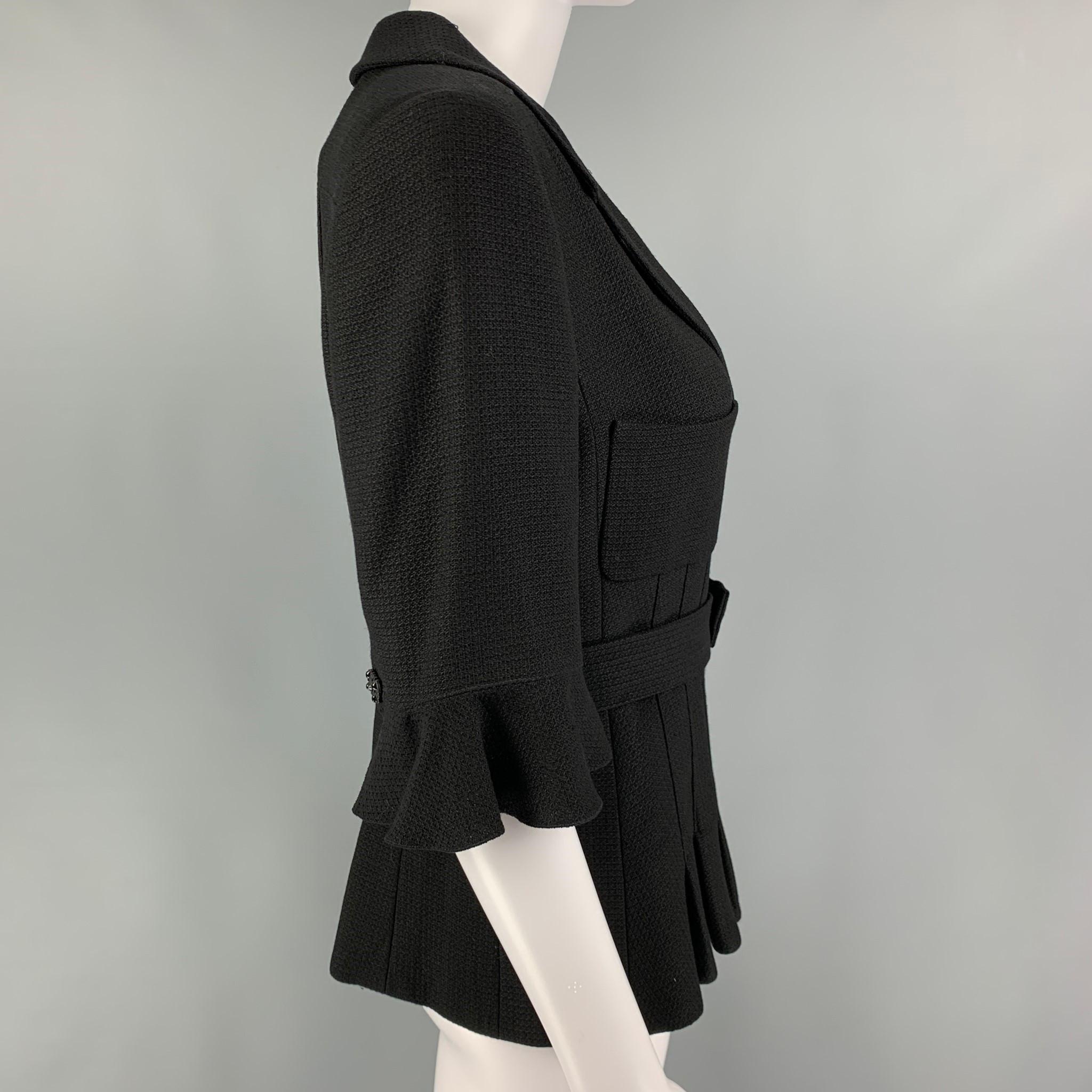CHANEL jacket comes in a black textured wool blend with a full liner featuring a belted style, pleated hem, 2/4 sleeves, notch lapel, and a buttoned closure. 

Very Good Pre-Owned Condition.
Marked: 07C 94305 40

Measurements:

Shoulder: 15.5