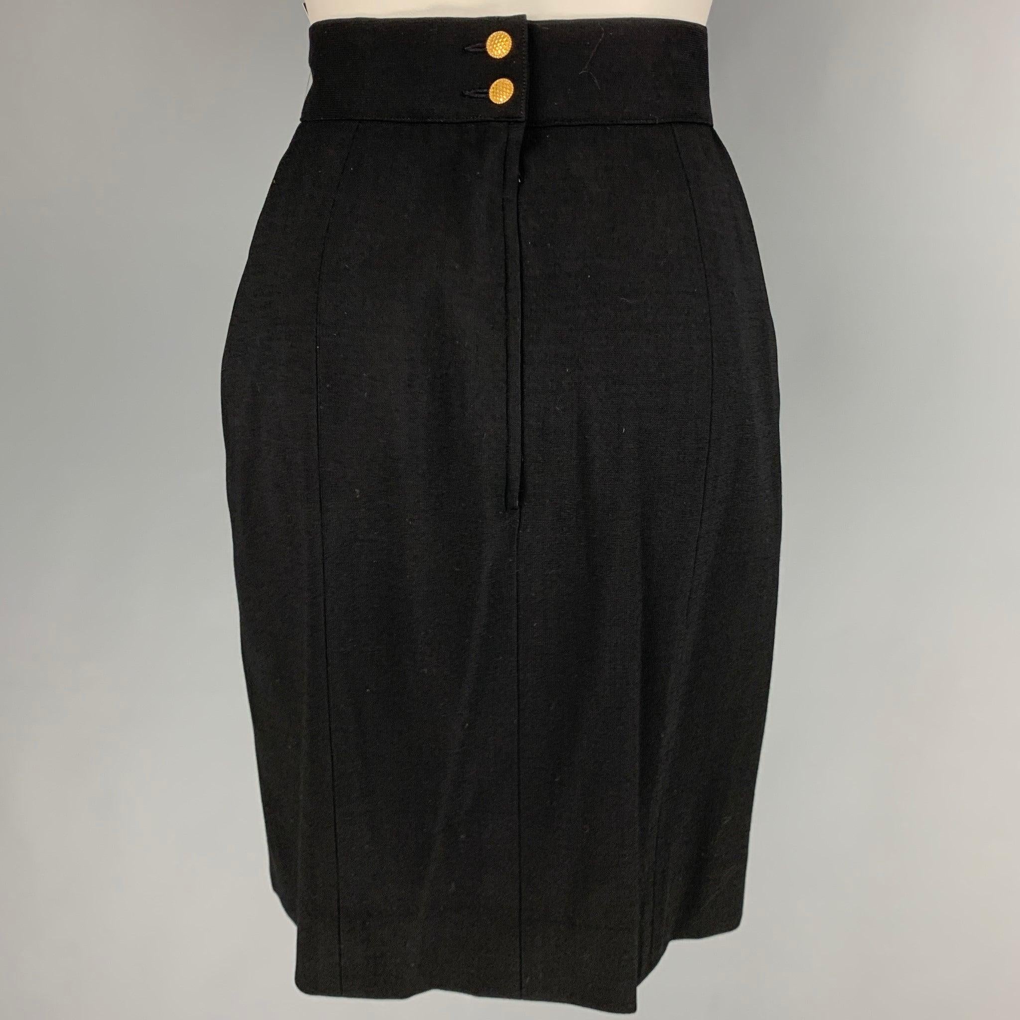 CHANEL skirt
in a black wool blend fabric featuring a below knee length, and back zipper closure with Chanel gold tone buttons. Made in France.Very Good Pre-Owned Condition. Minor signs of wear. 

Marked:   40 

Measurements: 
  Waist: 28 inches