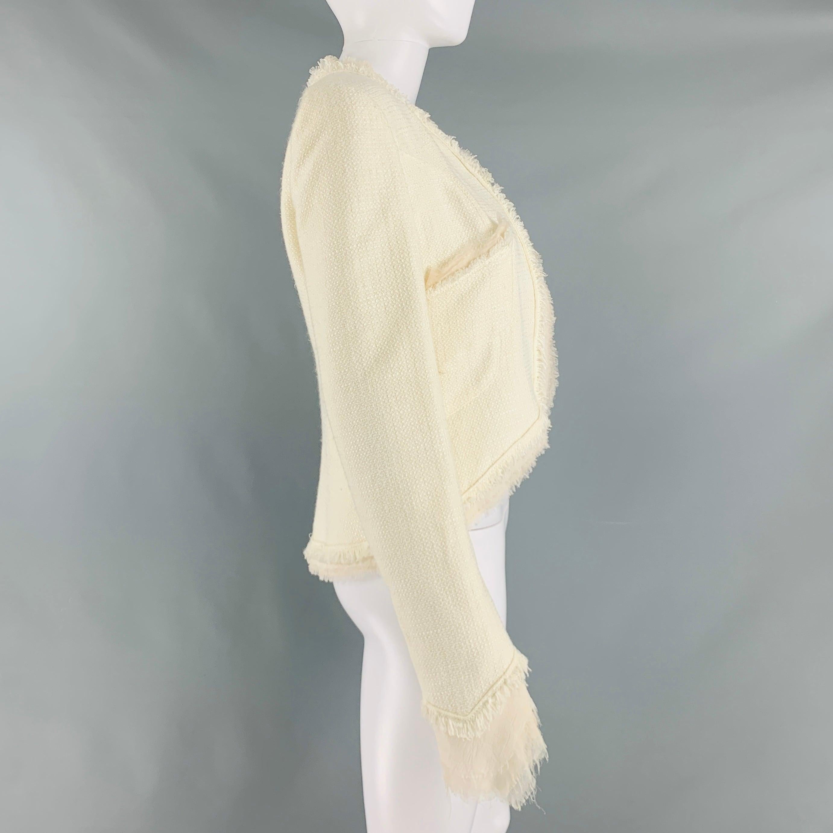 CHANEL 2004 jacket comes in a cream cotton acrylic featuring a raw edge, chiffon trim, two patch pockets, and an open front design. Made in France.Very Good Pre-Owned Condition. Very faint marks at front. 

Marked:   FR 40Shoulder: 15 inches Bust: