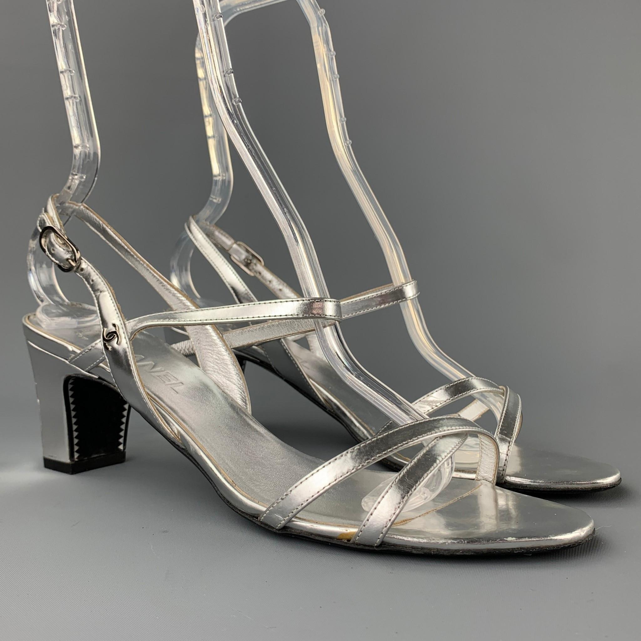 CHANEL sandals comes in a silver metallic leather featuring a strappy style, chunky heel, and a wooden sole. Moderate wear. Made in Italy.

Good Pre-Owned Condition.
Marked: EU 39.5

Measurements:

Heel: 2.5 in.