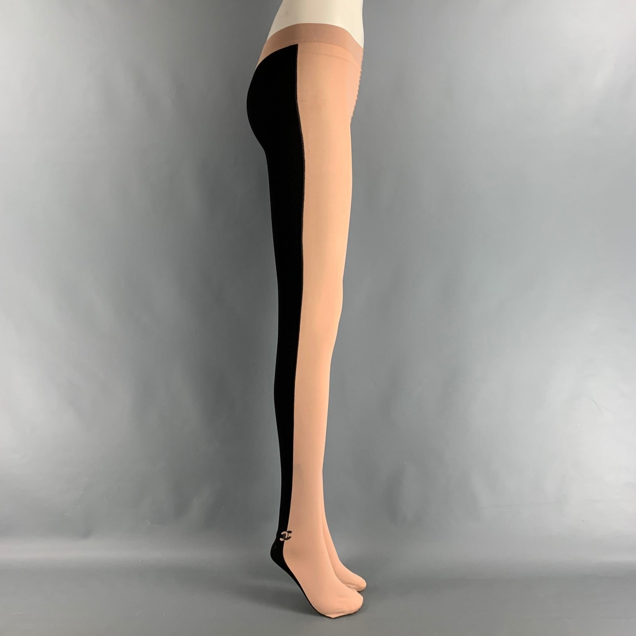 CHANEL leggings comes in a black and nude nylon knit material features a CC logo detail at ankle, stretch wait and leg, and features a feet design. Made in Italy. Excellent Pre-Owned Condition. 

Marked:   M 

Measurements: 
  Waist: 20 inches