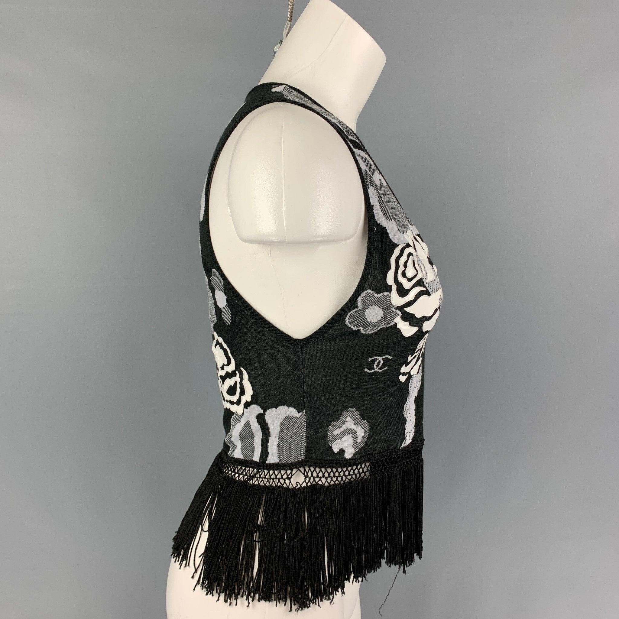 CHANEL top comes in a black & white floral cotton / rayon featuring a v-neck, fringe trim, and a buttoned closure.
Very Good
Pre-Owned Condition. Logo tag removed.  

Marked:   Size tag removed 

Measurements: 
 
Shoulder: 12 inches  Bust: 26 inches
