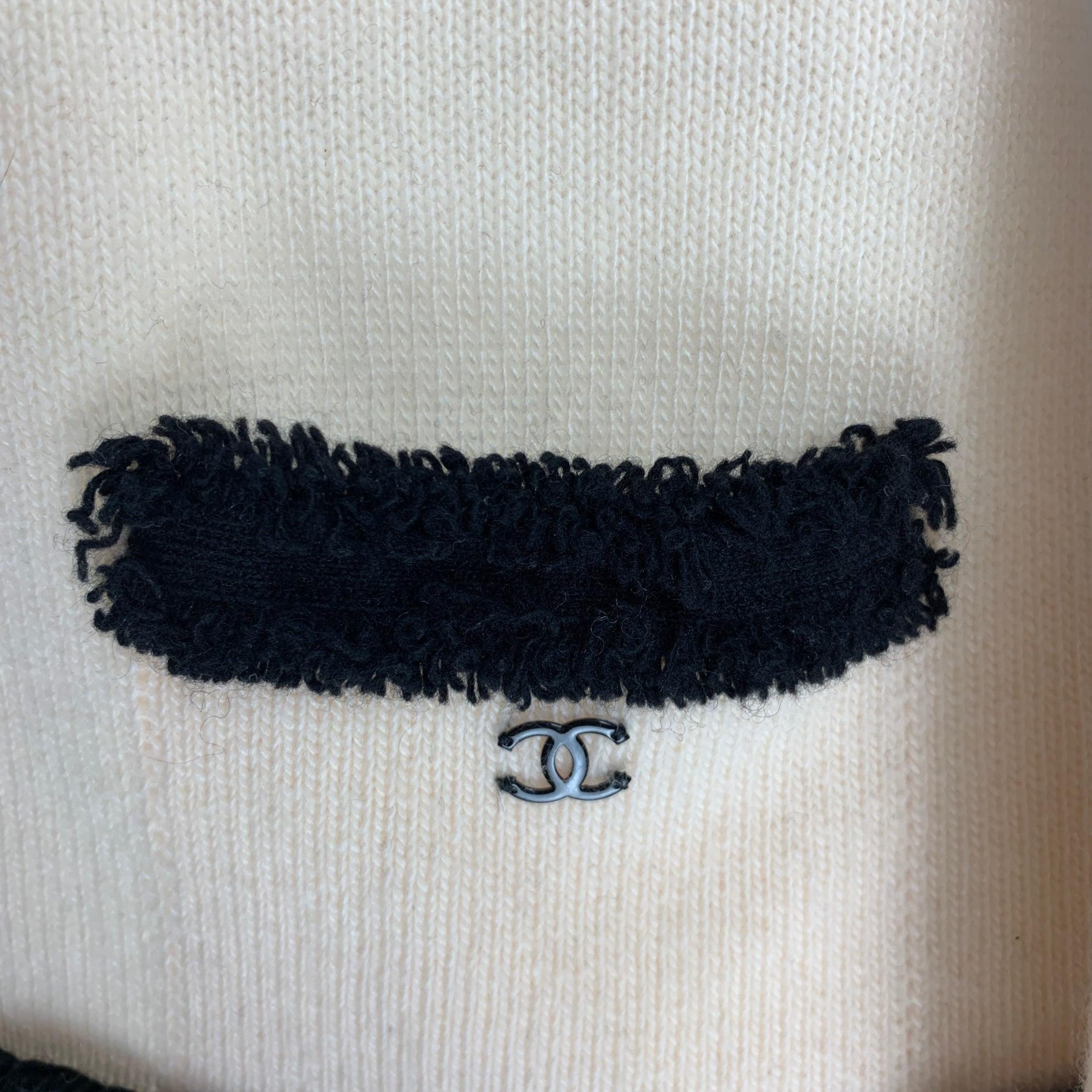 CHANEL Cardigan comes in a cream cashmere knit material featuring a raw edge, black accents, four patch pockets, and an open front design. Made in France.Very Good Pre-Owned Condition. Labels Removed. 

Marked:   no size marked.Shoulder: 14.5 inches