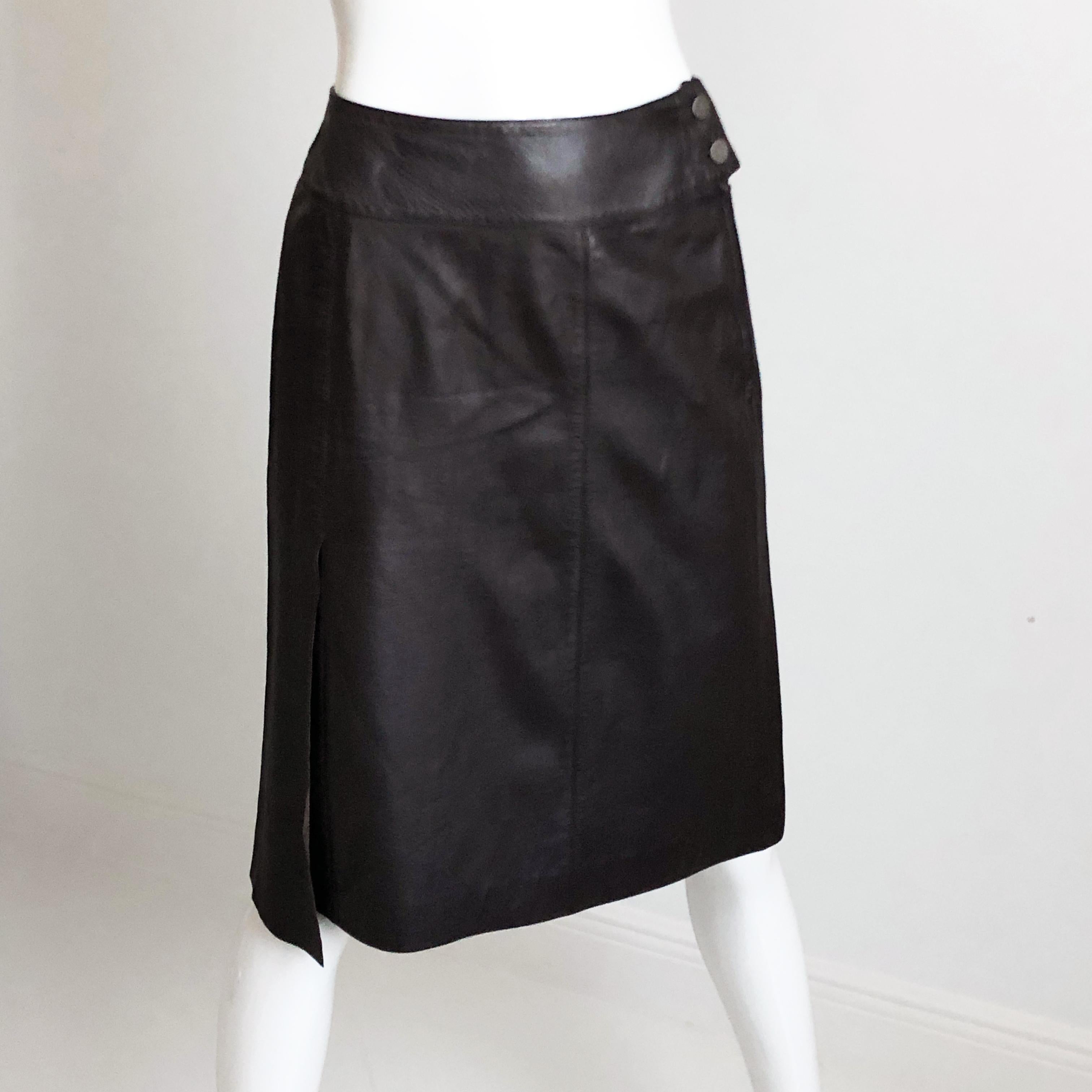 Authentic, preowned Chanel mocha brown lambskin leather skirt, size 36 from the 99P collection . CC logo stamped buttons with hidden zip fastener; fully-lined in silk with an asymmetric vent panel at the wearer's right side. Preowned with minimal