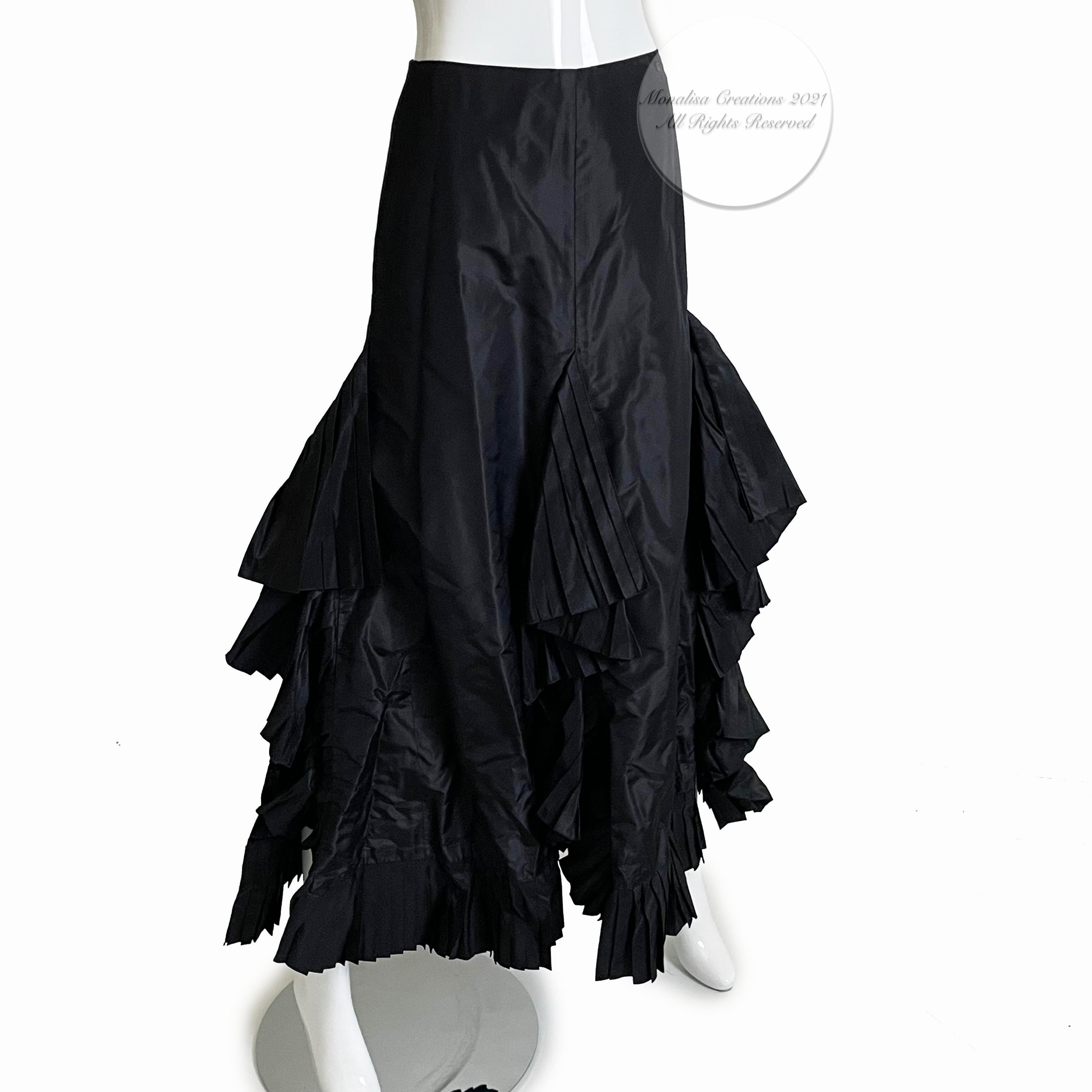 This incredible silk taffeta skirt is constructed with panels of pleated ruffle fabric, fitted at the waist and hips, and features an asymmetric hem.  One flat pocket can be found at each hip, and there is one rhinestone-encrusted CC on the left