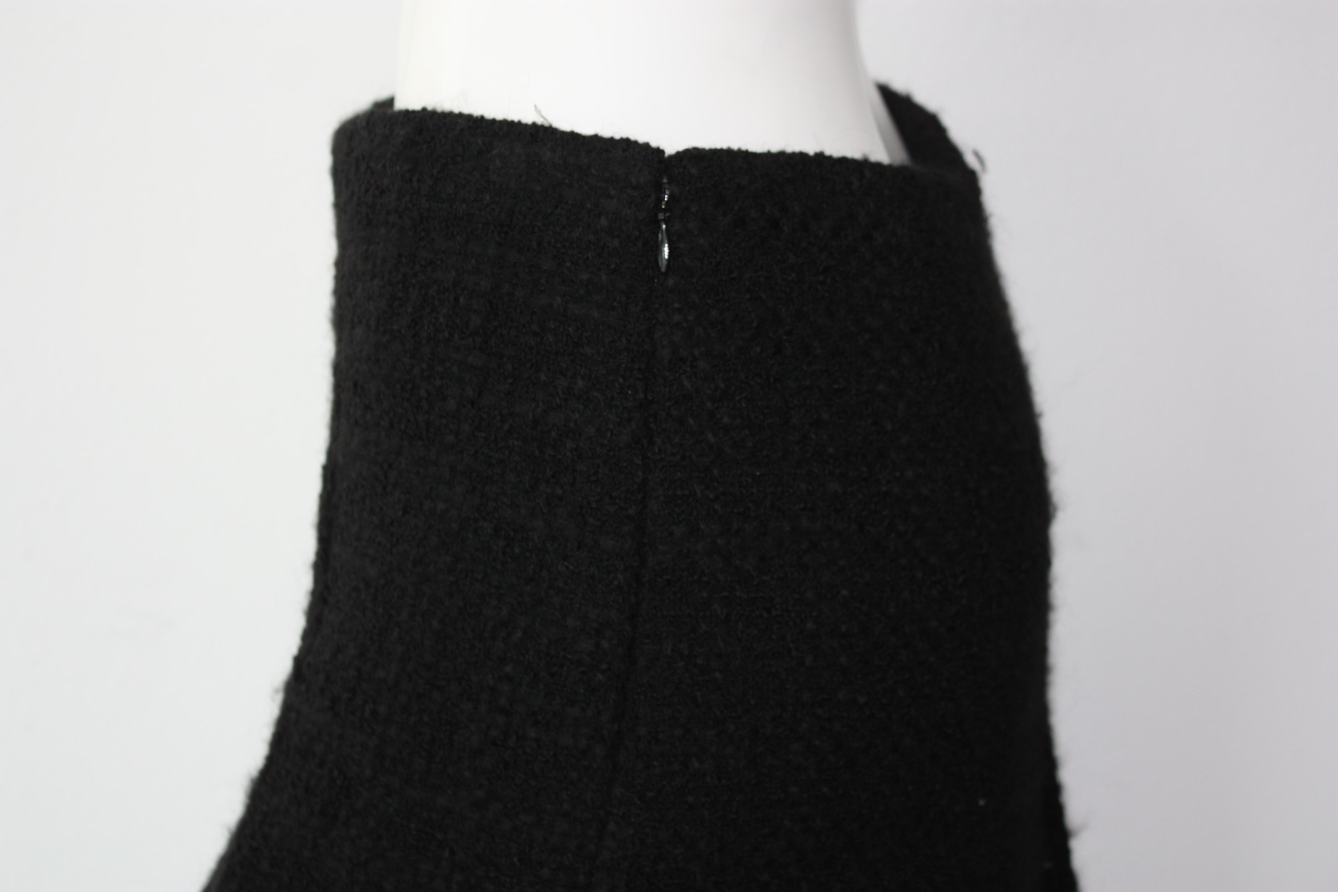 CLASSIC Chanel black tweed mini skirt. 
This skirt is a such a staple/classic edition to your wardrobe. 
New with tags, never been worn. 
Size 36
Retails for over $1500
