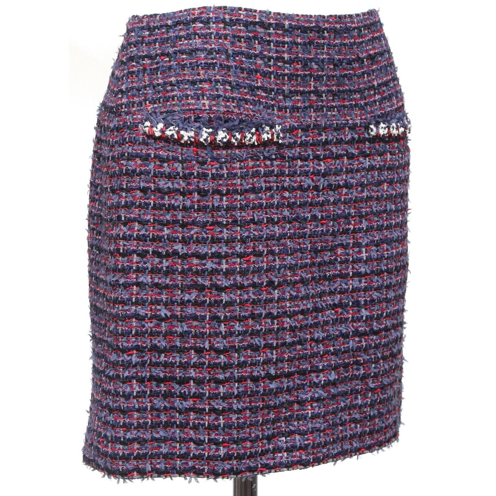 GUARANTEED AUTHENTIC CHANEL CRUISE 2013 TWEED ABOVE THE KNEE SKIRT

Details:
- Stunning fantasy tweed skirt in blue, red and black.
- Dual front pockets.
- Gold-tone metal CC plaque found at left hip.
- Rests above the knee.
- Back zipper with