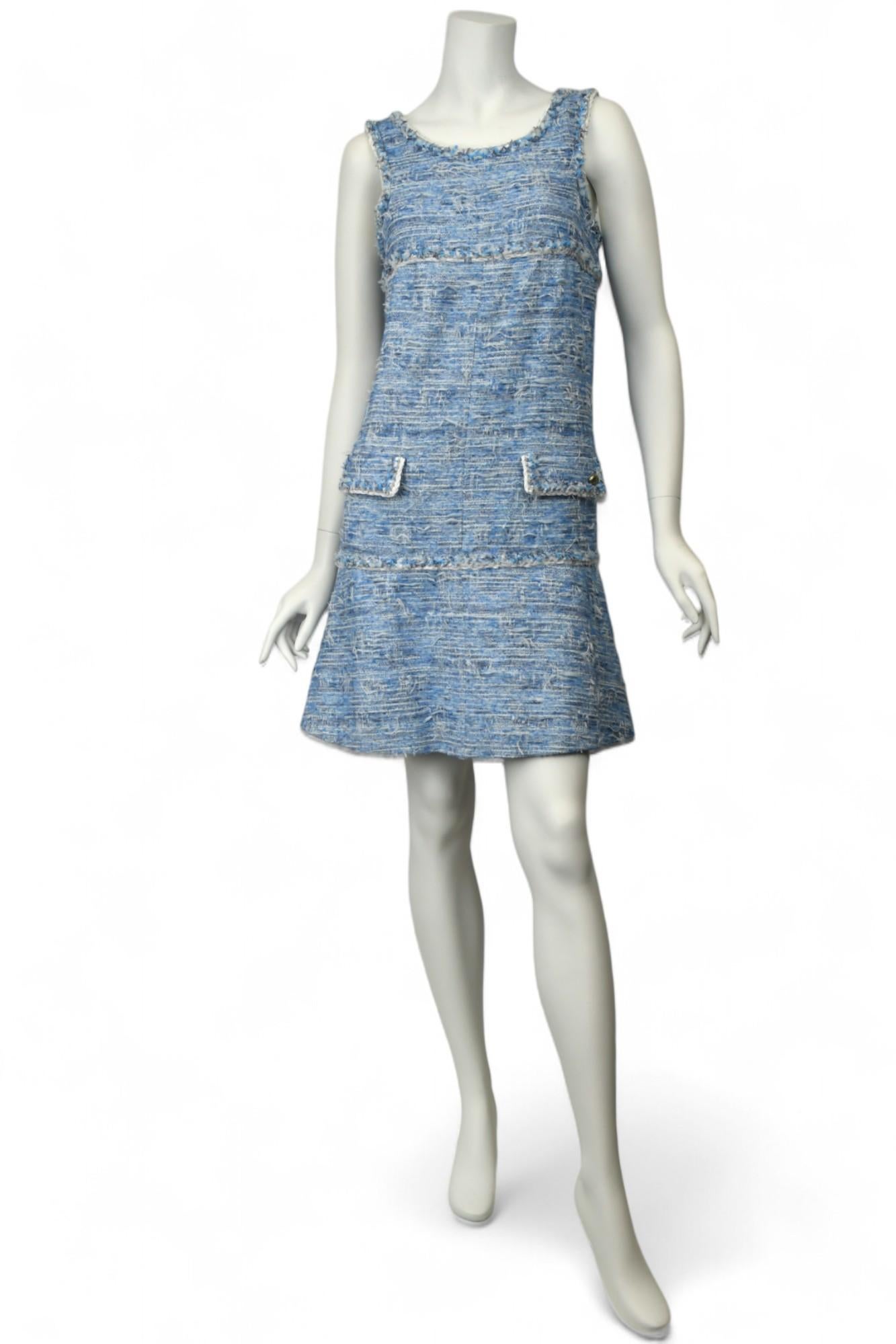 This rare Chanel 15P collection dress captures the maison's signature blend of texture and tailoring in a playful sleeveless silhouette. Crafted from richly woven sky blue and white fantasy tweed, the dress features intricate fringe detailing,
