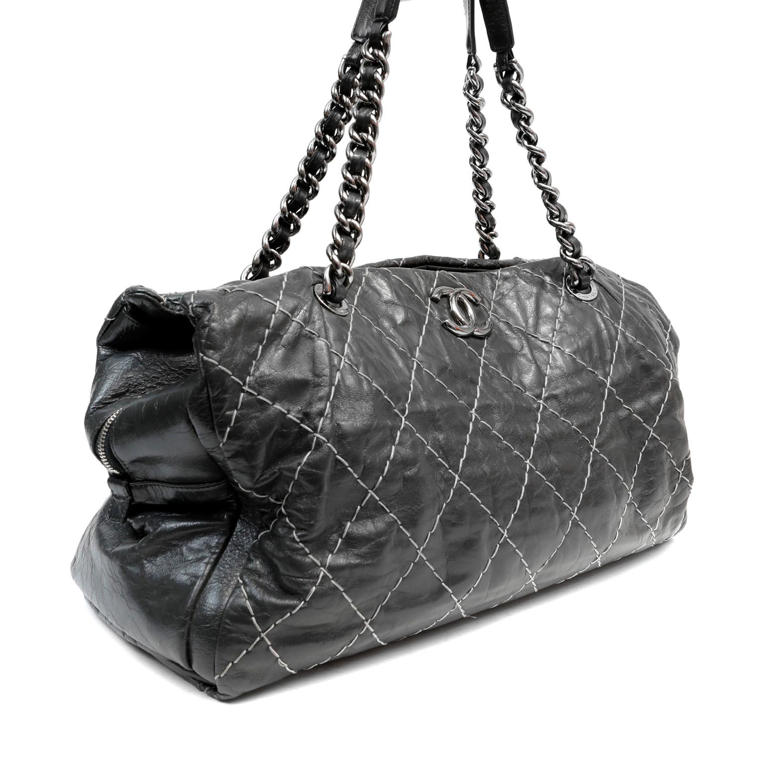 This authentic Chanel Slate Topstitched Distressed Leather Large Tote is in pristine condition.  Internationally distressed dark slate leather is topstitched in signature Chanel diamond pattern.  Spacious and double-sided style with silver tone