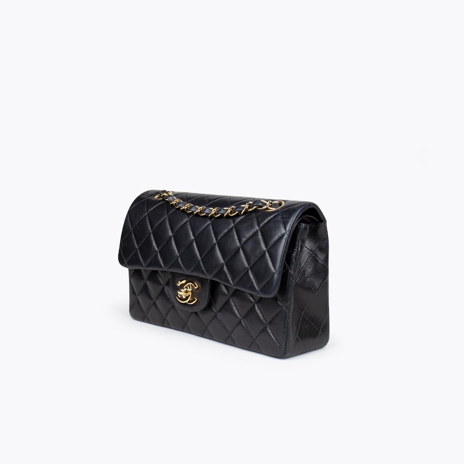 Black quilted lambskin Chanel Small Classic/Timeless Double Flap bag with

– Gold-tone hardware
– Convertible chain-link and leather shoulder strap
– Burgundy leather lining
– Single patch pocket at back
– Single zip pocket at flap underside, three