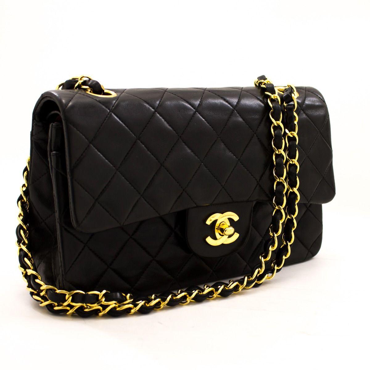 This iconic Chanel 9 inch double flap bag is crafted from quilted black lambskin and features a double flap. On the front flap there is the classic CC logo twist lock and on the second flap a stud closure with one slip-in pocket. The inside lining