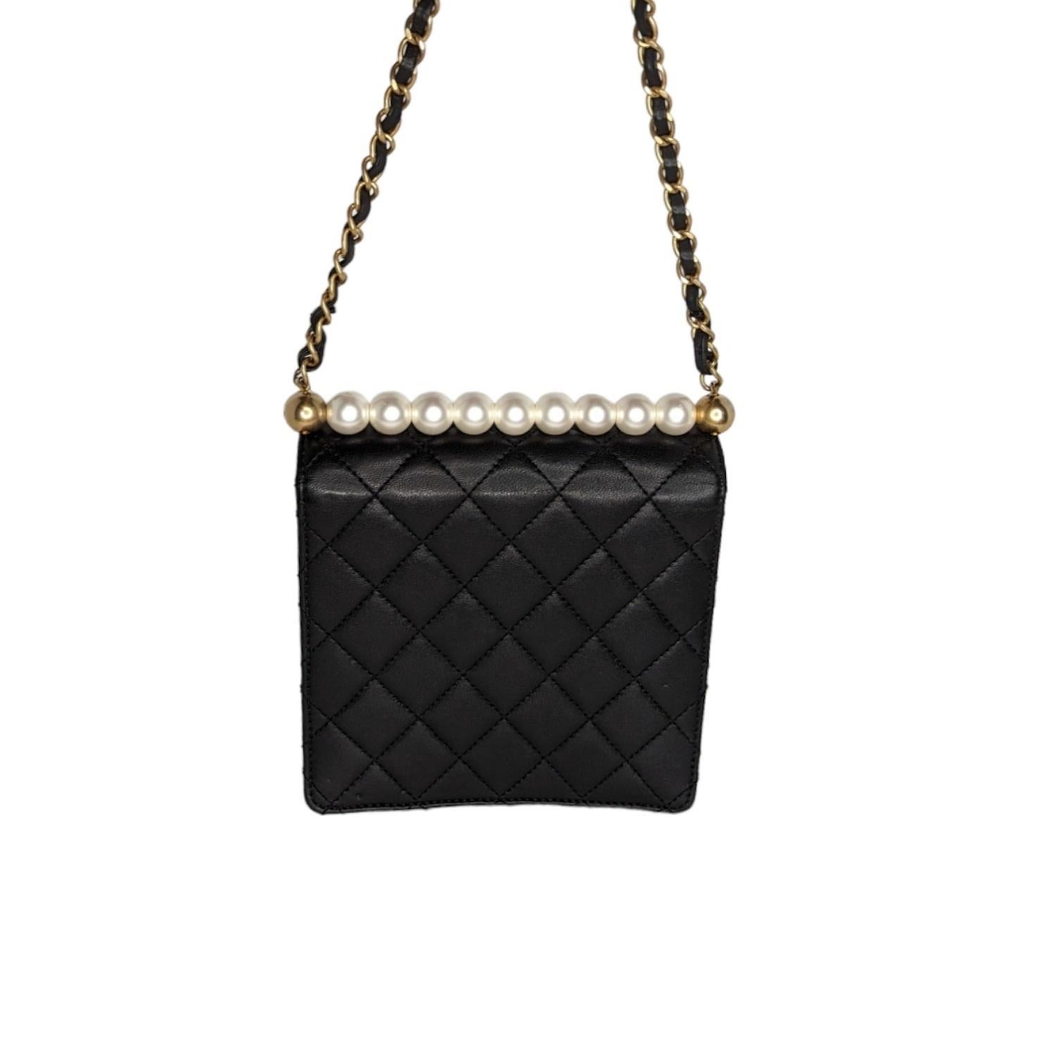 Chanel Goatskin Quilted Chic Pearls Flap in Black. This stylish shoulder bag is crafted of diamond-quilted textured goatskin leather. The bag features leather threaded aged gold chain strap, imitation pearls aligned on the top, and a flap with an