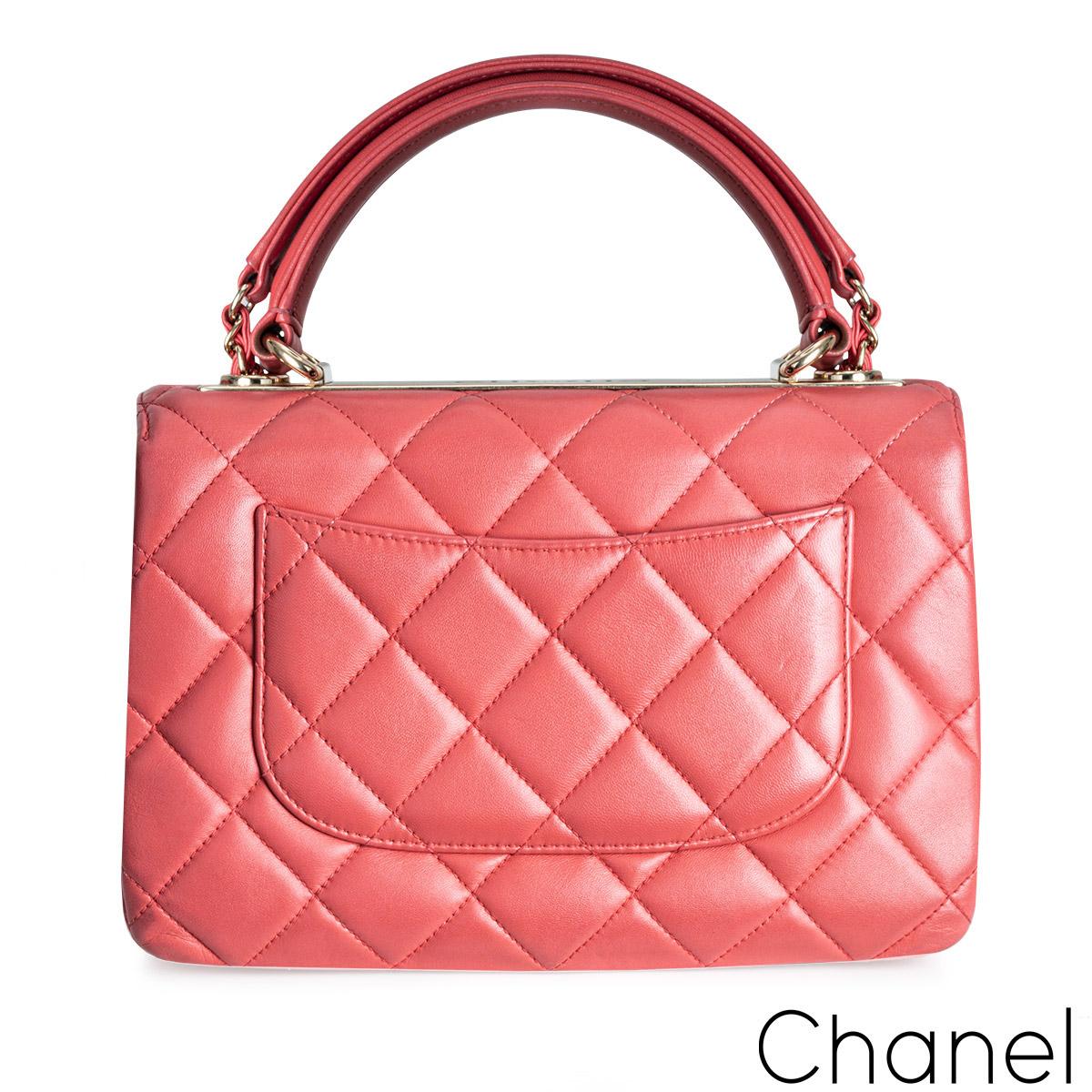 A stylish pink Chanel Small Trendy CC Flap Bag. The exterior of this Trendy is crafted with pink lambskin leather in the signature diamond style stitching and gold tone hardware. It features a front flap with signature CC turnlock closure, half moon