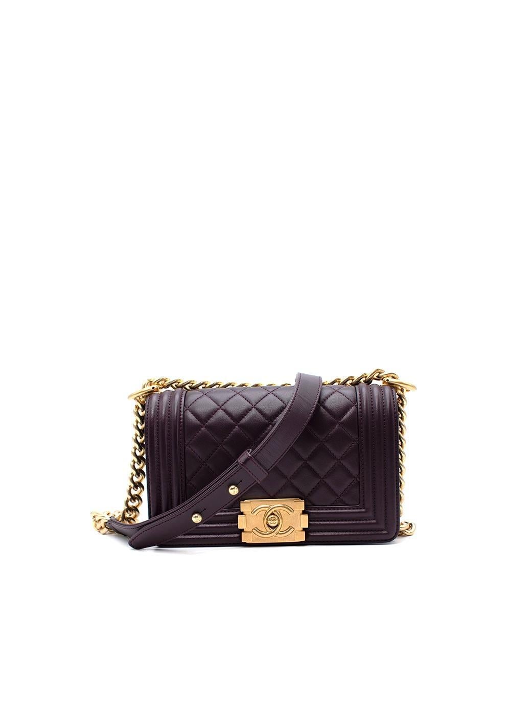 Chanel Small Purple Lambskin Boy Bag

- Classic Boy style with a full front flap rendered in warm plum purple
- CC push-lock closure
- Gold chain link and dark purple leather padded shoulder/crossbody strap.
- Gold hardware
-