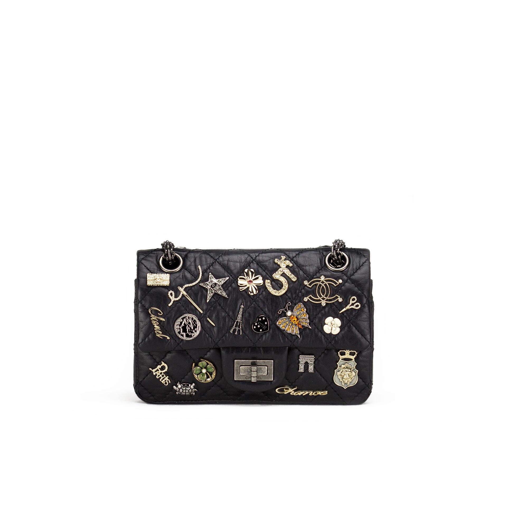 Quilted Chanel black lambskin charmed flap with mademoiselle closure and reissue chain

Year: 2012
Antique silver hardware
Interior flap zippered pocket
Interior flap
Interior open pockets
Interior engraved cc logo
Classic back pocket
8” W x 5” H x