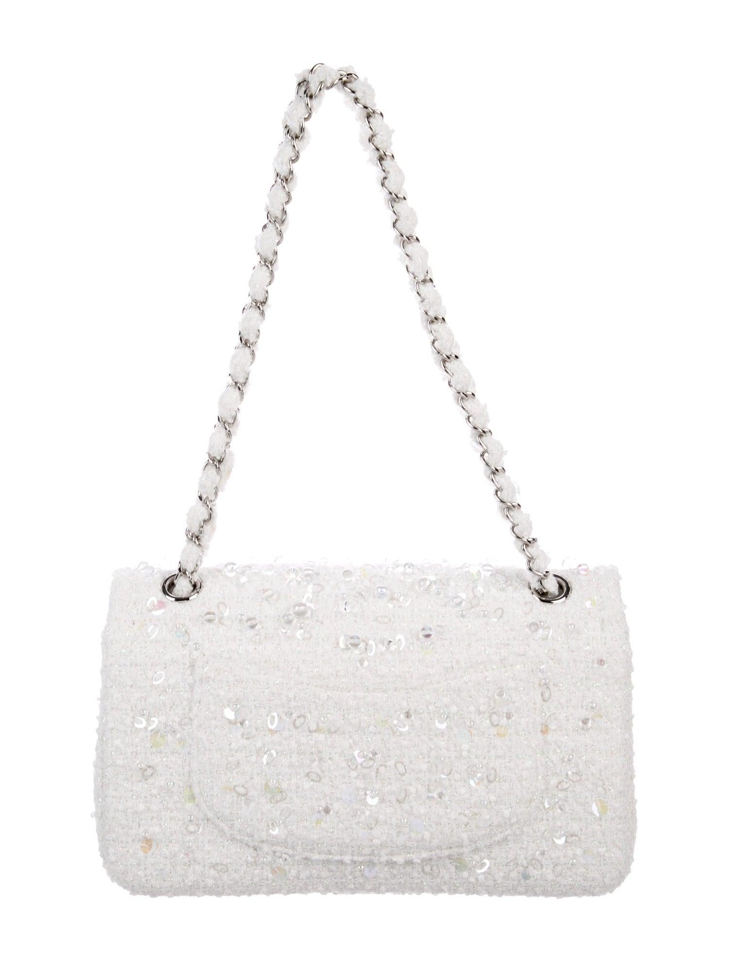 The Most Luxurious of Chanel Bags.

Combining classic Chanel tweed with intricate iridescent beading, this well-maintained Chanel flap bag is a beautiful sight to behold. Featuring winter white tweed and silver tone hardware, it’s a strikingly