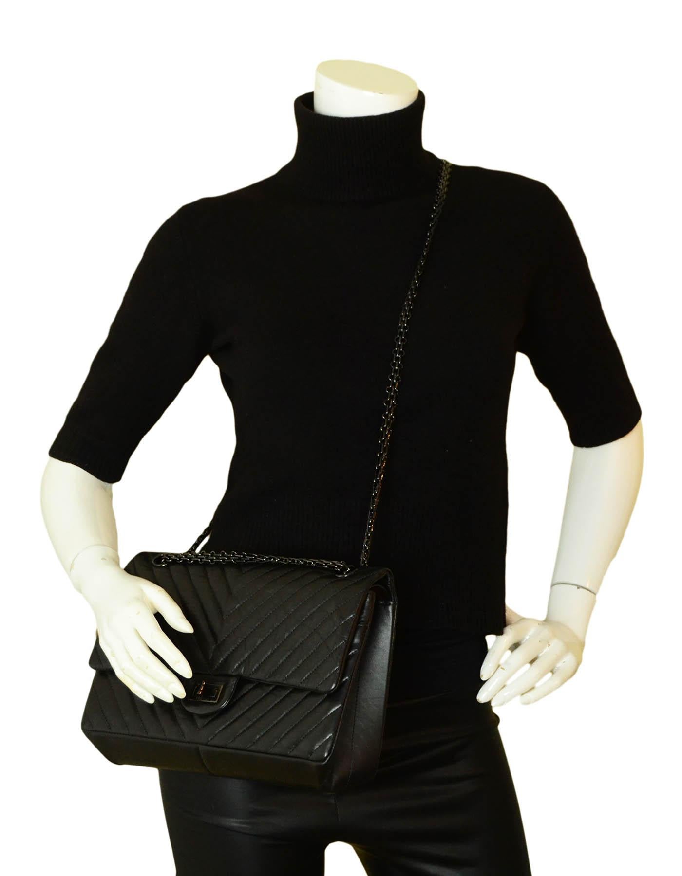 Chanel So Black Calfskin Quilted Large 2.55 Reissue 226 Double Flap Bag

Made In: Italy
Year of Production: 2018
Color: Black
Hardware: Black
Materials: Aged calfskin
Lining: Burgundy smooth leather
Closure/Opening: Flap top with reissue