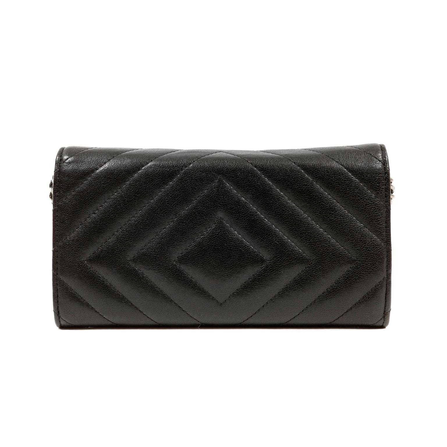 This authentic Chanel So Black Chevron Leather Wallet on a Chain is in excellent condition.  Highly sought after, the WOC easily organizes coin and currency with style.
Black leather long wallet is quilted in chevron pattern.  All black mademoiselle