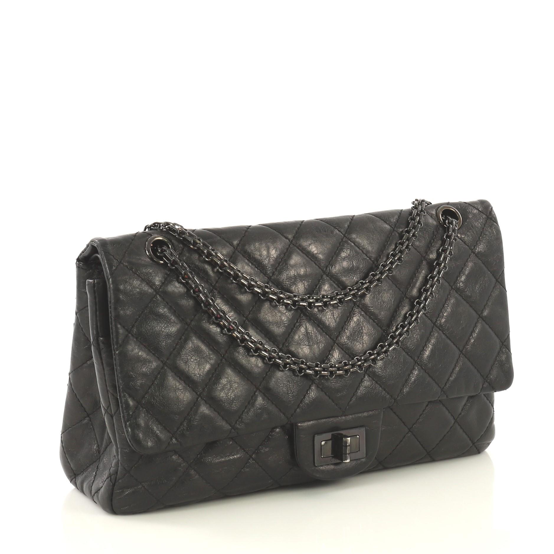 This Chanel So Black Reissue 2.55 Flap Bag Quilted Glazed Aged Calfskin 227, crafted from black quilted glazed aged calfskin leather, features reissue chain link strap, exterior back slip pocket, and black-tone hardware. Its mademoiselle turn-lock