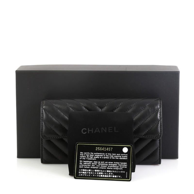 This Chanel So Black Reissue Flap Wallet Chevron Leather Long, crafted in black chevron leather, features black-tone hardware. Its turn-lock closure opens to a black fabric interior with multiple card slots and zip pocket. Hologram sticker reads: