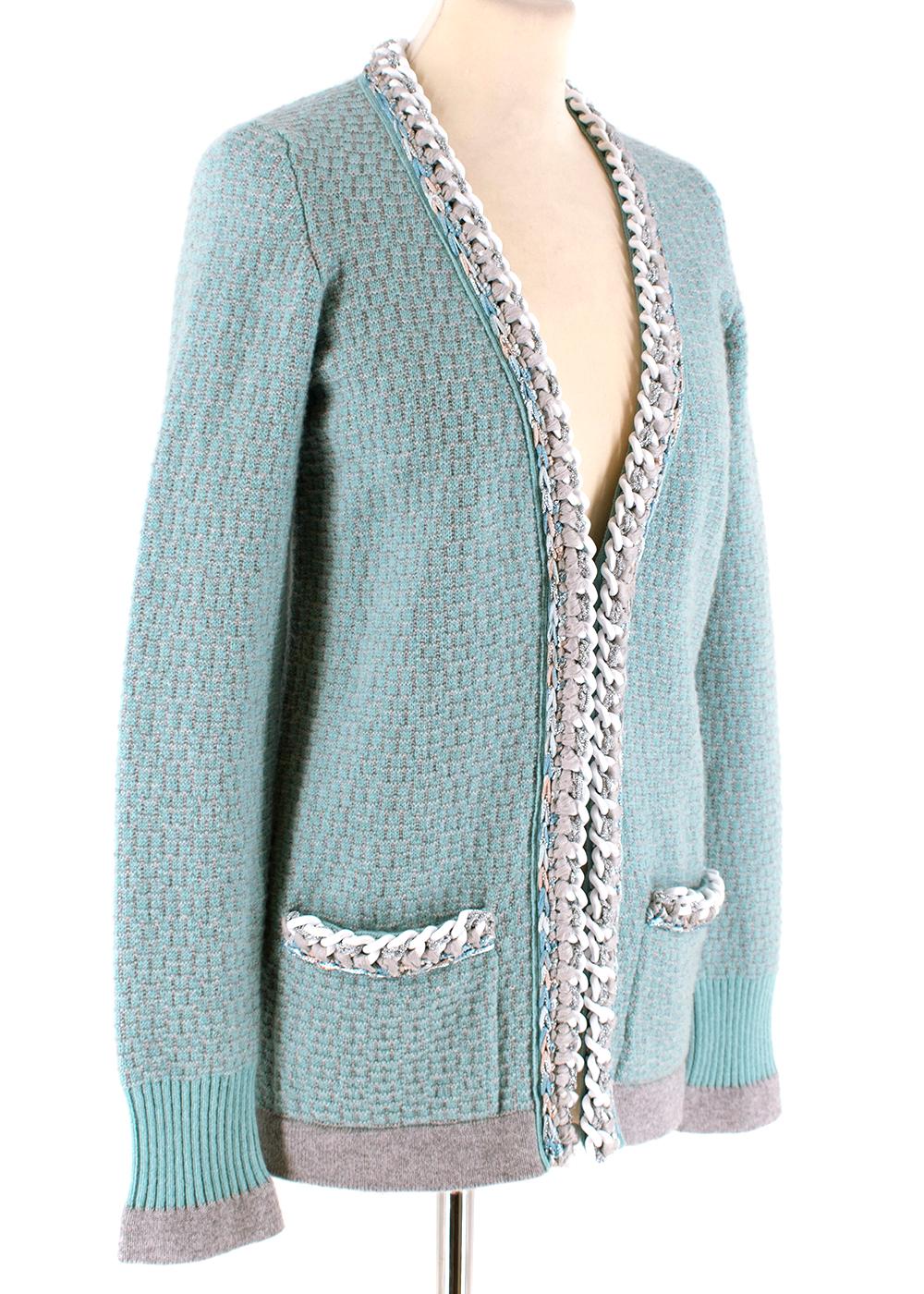 Chanel Soft Cashmere Knit Chain Trim Cardigan

- Soft thick cashmere knit 
- aqua green and grey contrast
- Chain trim and metallic threaded detailing across lapel and pocket trims 
- Front patch pockets
- Ribbed knit cuffed sleeves and hem 
-