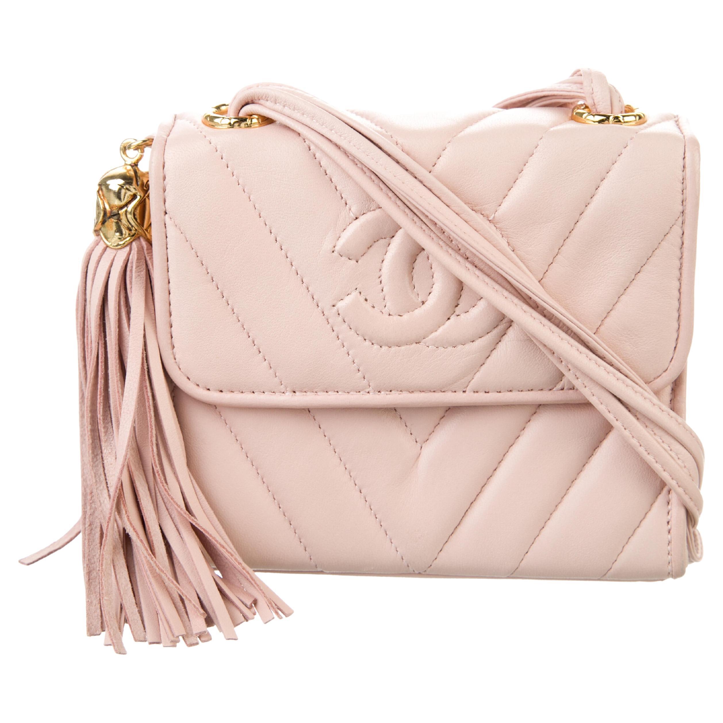 Chanel Soft Pink Chevron Fringe Lambskin Flap Bag

1989 {VINTAGE 35 Years}
CC logo Stitched detail
Magnetic clasp closure
Beige interior lambskin lining
Center zippered pocket
Hanging Fringe Detail
Multi Strand Strap
Strap Drop: 22