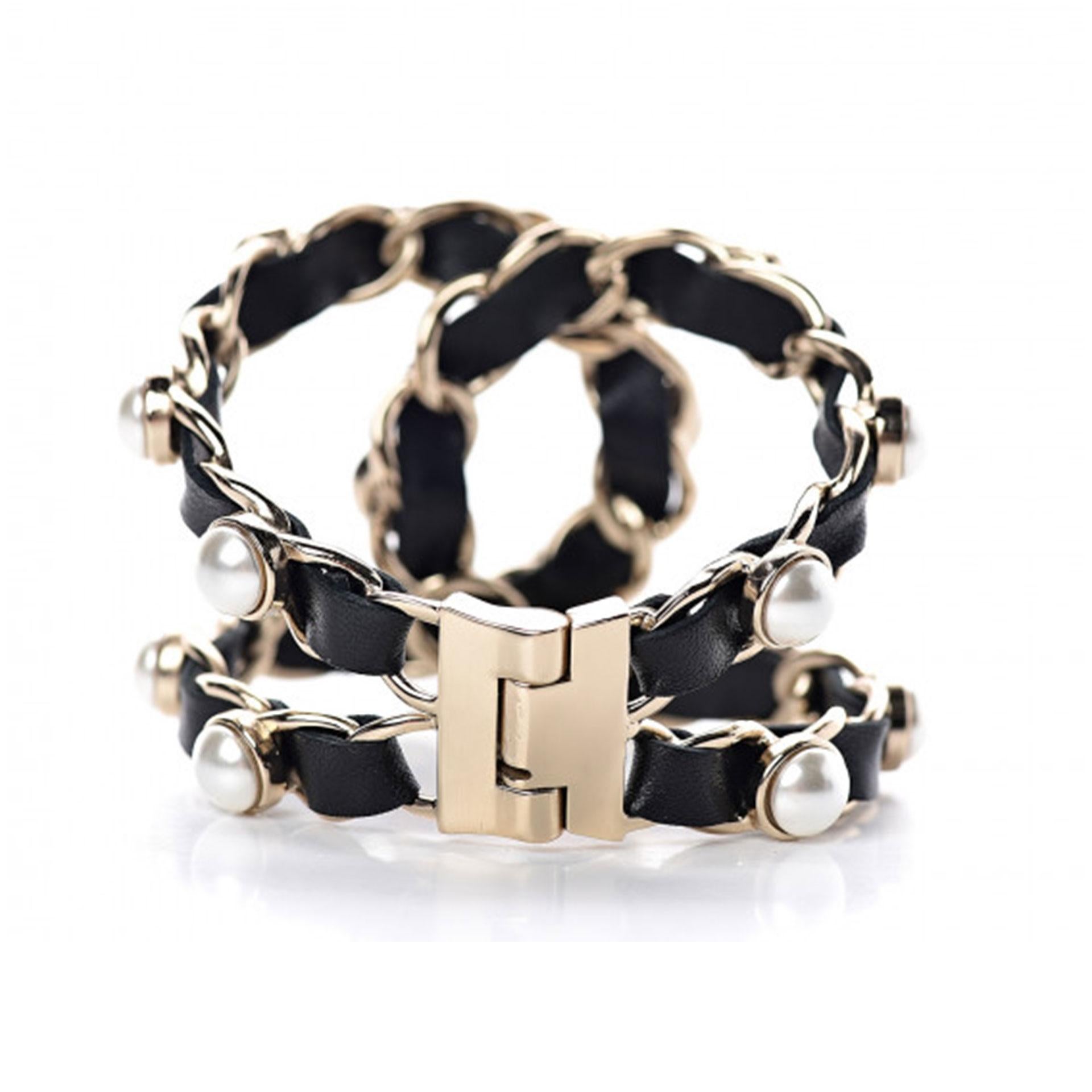 Chanel Soldout Black Lambskin Pearl Chain Gold Cuff Bracelet

This bold and gold tone cuff features faux pearls and black lambskin leather threaded through the chains to form a stunning Chanel CC logo when closed. This is an excellent cuff with the