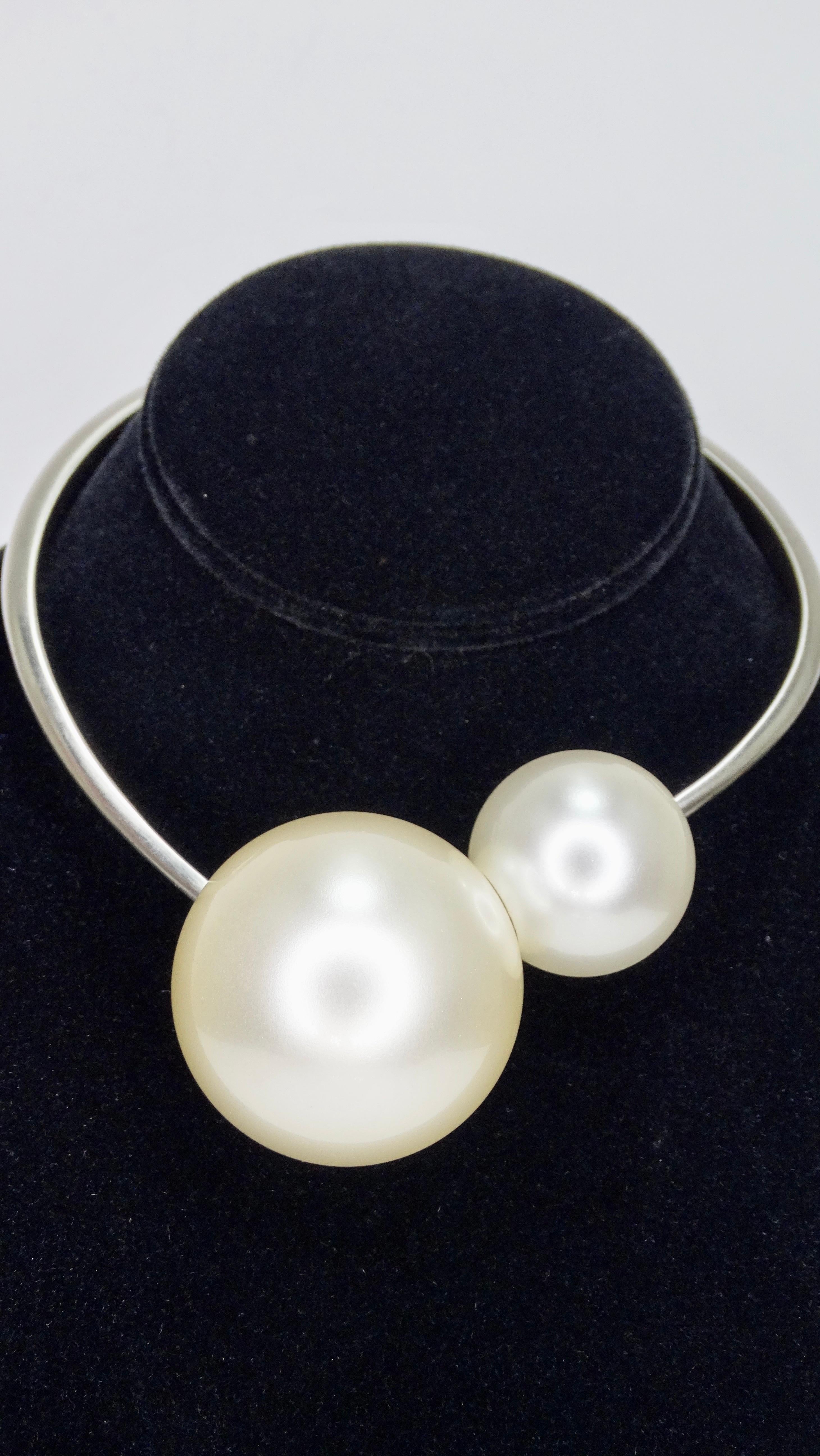 Let's talk timeless! Circa 2014 from their Spring collection, this choker features large double faux pearls on a silver spiral/free form band stamped 'Chanel'. Has a magnetic closure and is stamped on the interior of band. Classic with a twist, this