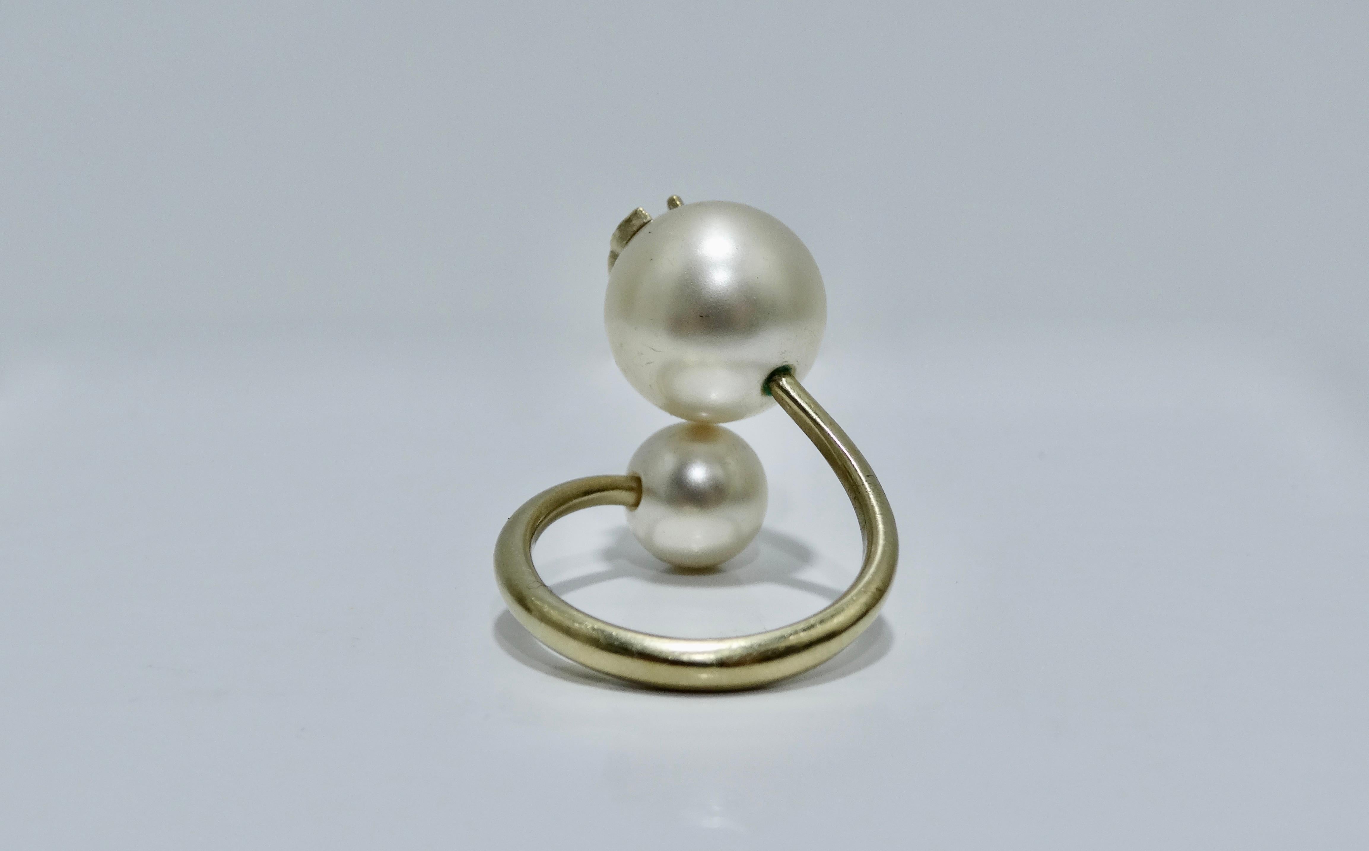 Let's talk timeless! Circa 2014 from their Spring collection, this classic ring features double faux pearls with the iconic CC on a gold plated spiral/free form band. This gorgeous ring is the perfect way to accessorize any outfit. Wear on its own