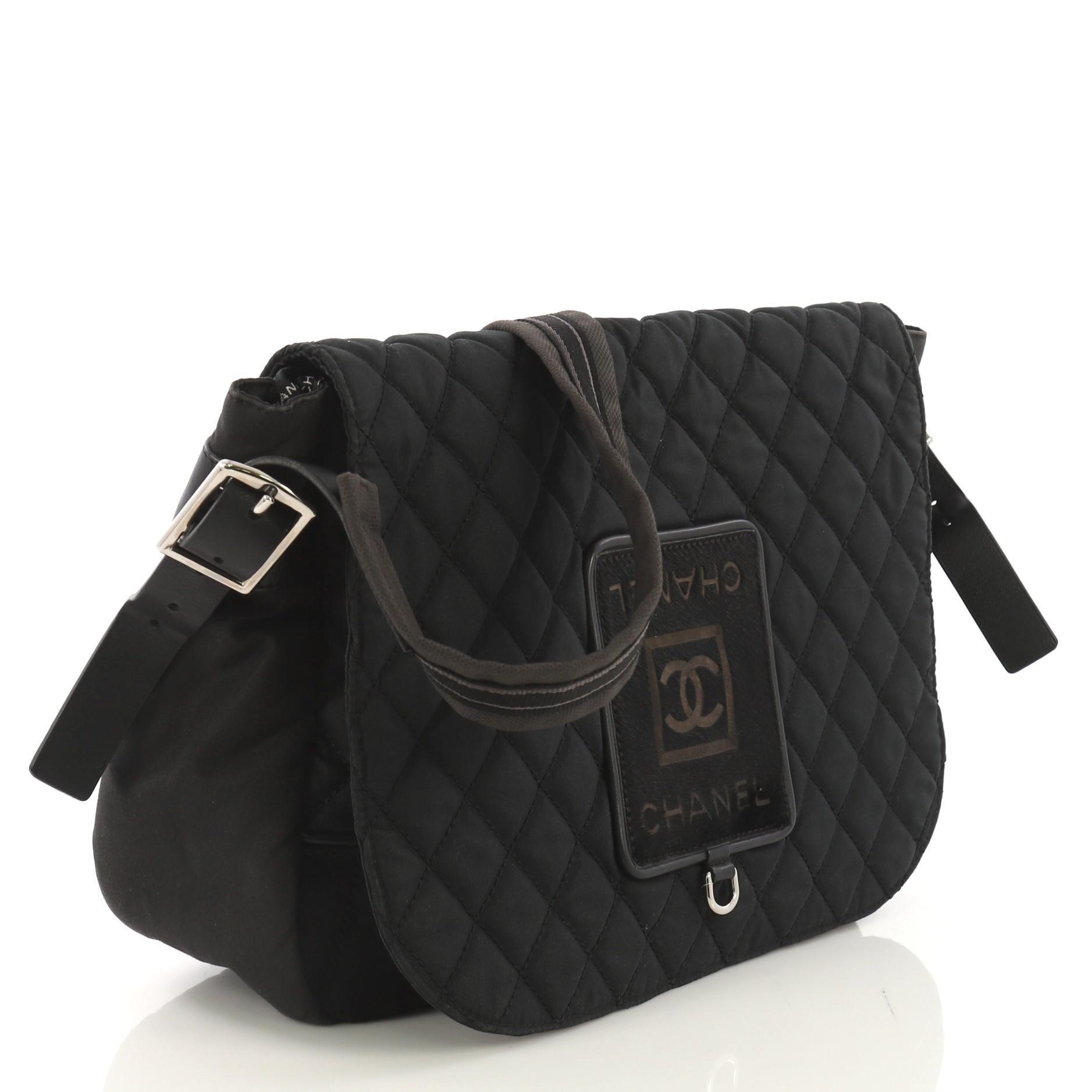This Chanel Sport Line Messenger Bag Quilted Nylon with Pony Hair Large, crafted from black quilted nylon with pony hair, features CC logo on its front flap, cross-body strap, and silver-tone hardware. Its flap opens to a black nylon interior.