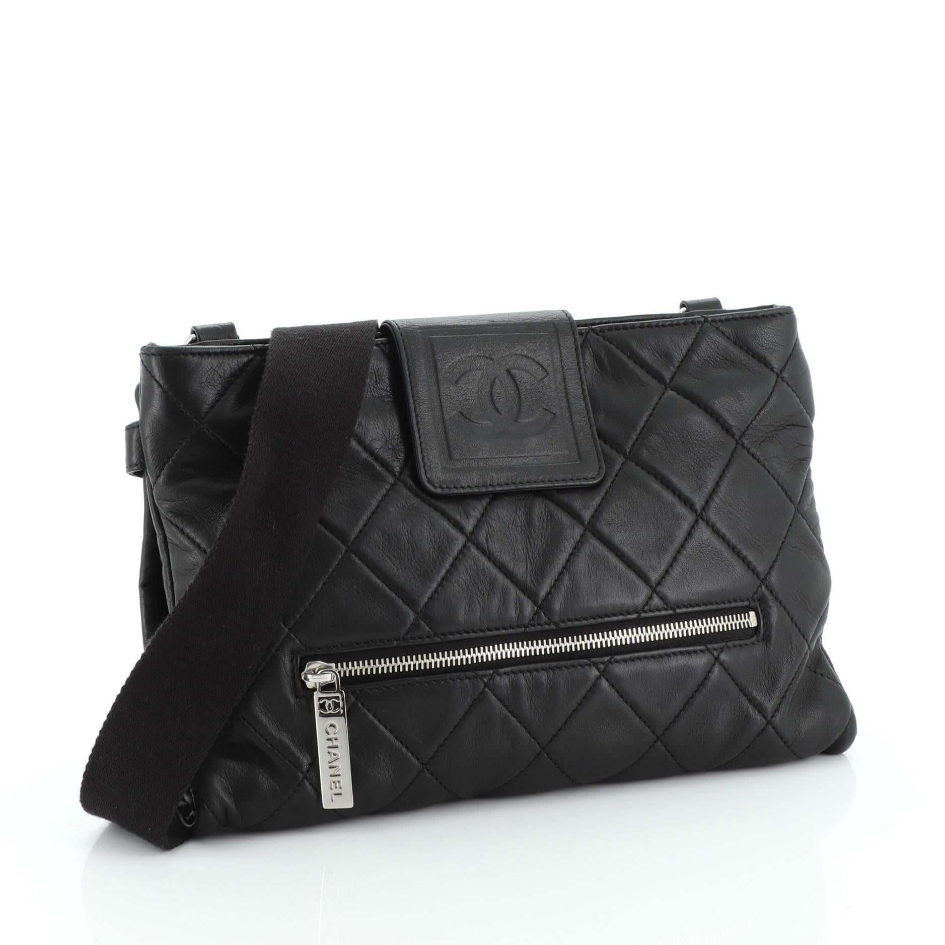 This Chanel Sport Line Zip Messenger Bag Quilted Lambskin Medium, crafted from black quilted lambskin leather, features long shoulder strap, exterior front zip pocket, and silver-tone hardware. Its flap tab and zip closure opens to a black fabric