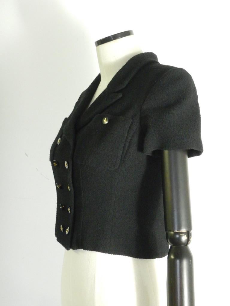 This is a button-front Chanel wool (95%) and nylon (5%) jacket in black, with a black silk CC-logo lining, made for the Spring 1995 collection. 

The jacket is tagged size 38.

This jacket is in good vintage condition. The jacket is clean and seems