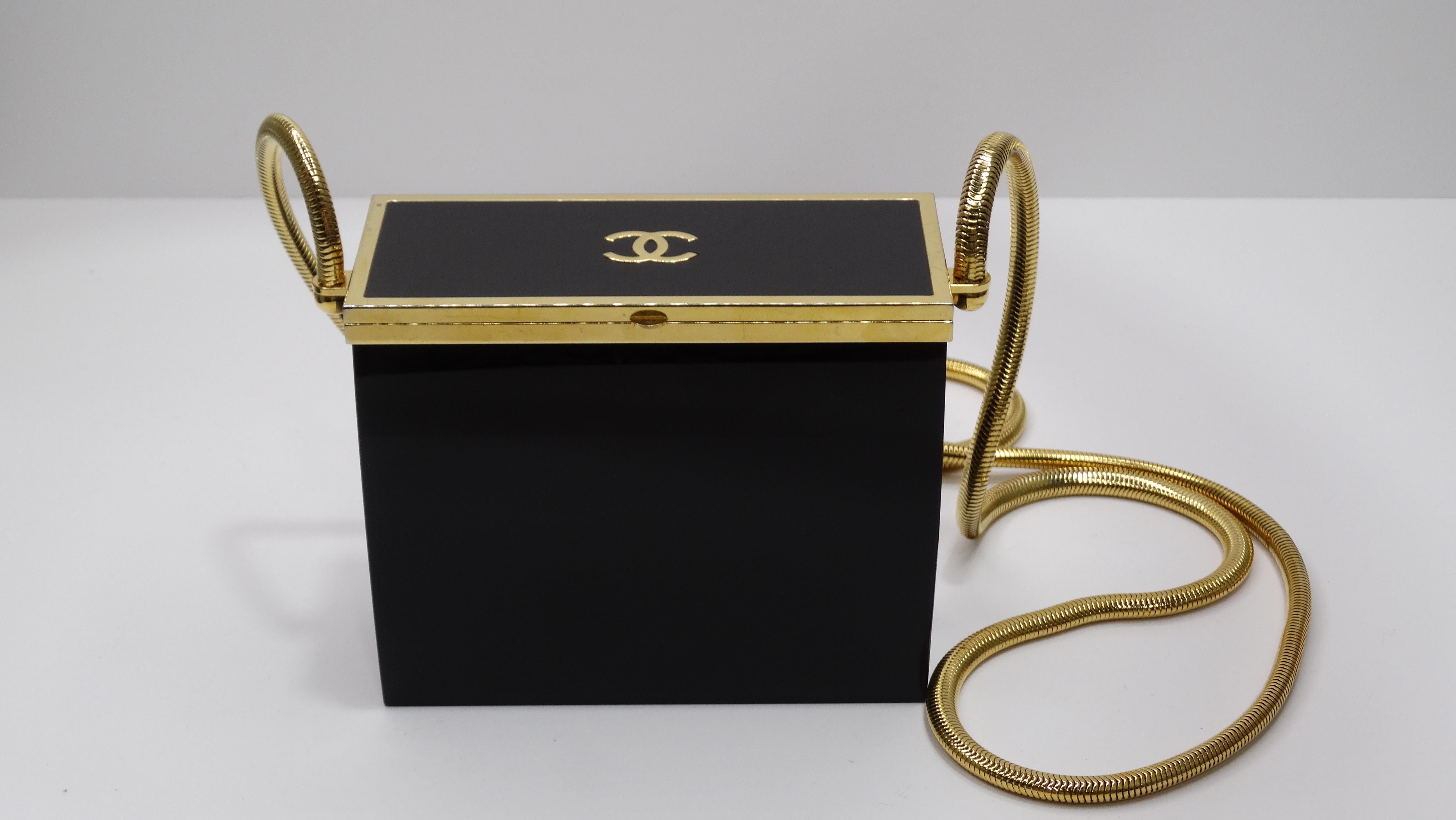 A beautiful vintage Chanel Spring 1997 find! This is a major conversation piece as there won't be a single person who won't notice this gem. Black acrylic body with a push-lock closure boldly contrasts with gold framing, gold 