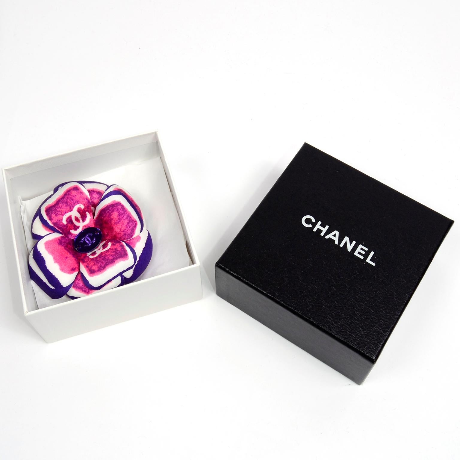 This is a very unique Chanel multicolored silk camellia brooch from the Chanel Spring 2001 collection. It comes with its original tag and box. This lovely flower brooch has a purple edge with white and pink/purple center with CC marked along the
