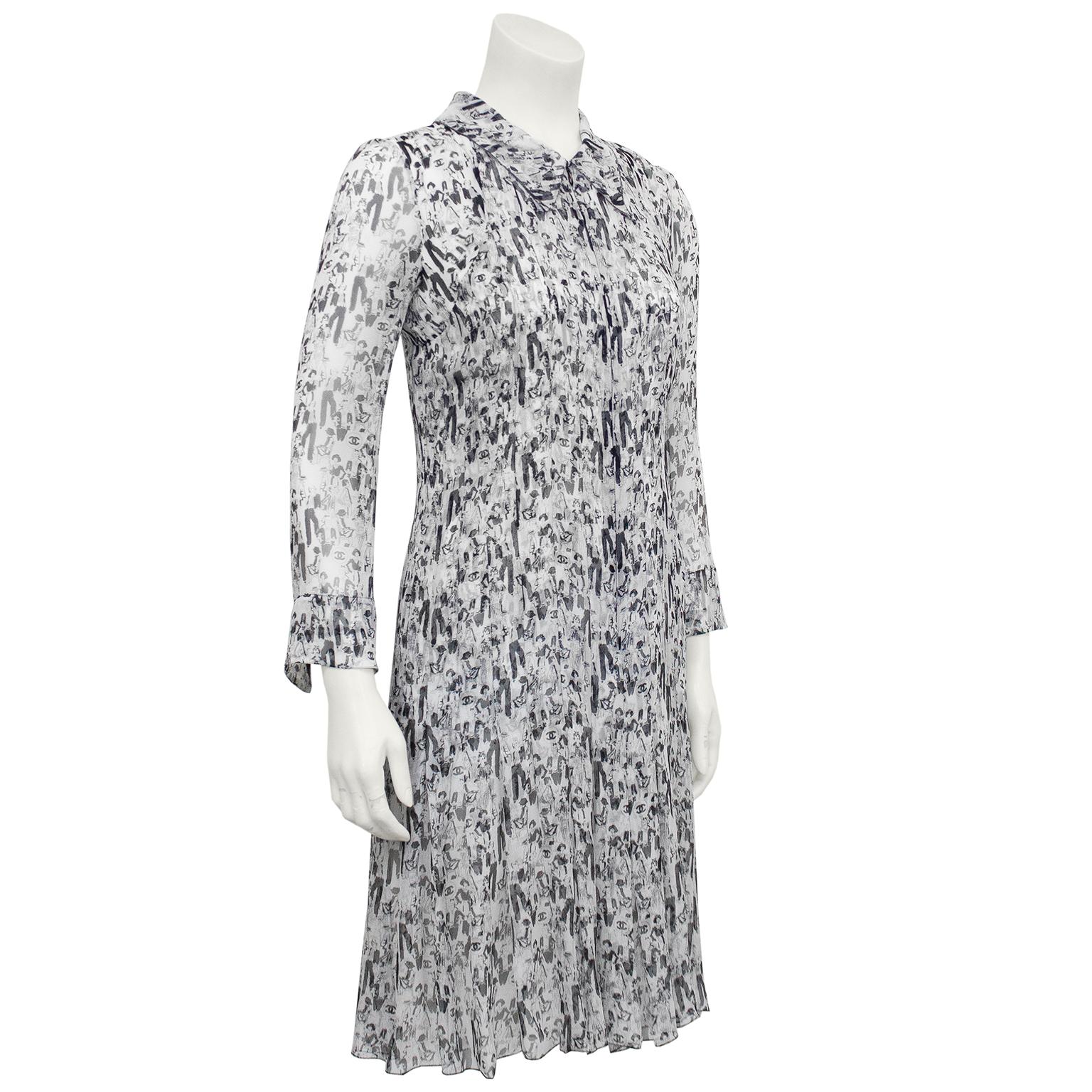 Stunning Chanel shirtdress from the Spring 2003 collection. Black and white 100% silk chiffon with an all over print of Coco Chanel in different classic and iconic Chanel outfits and the CC logo throughout. Long sheer sleeves, convertible collar and